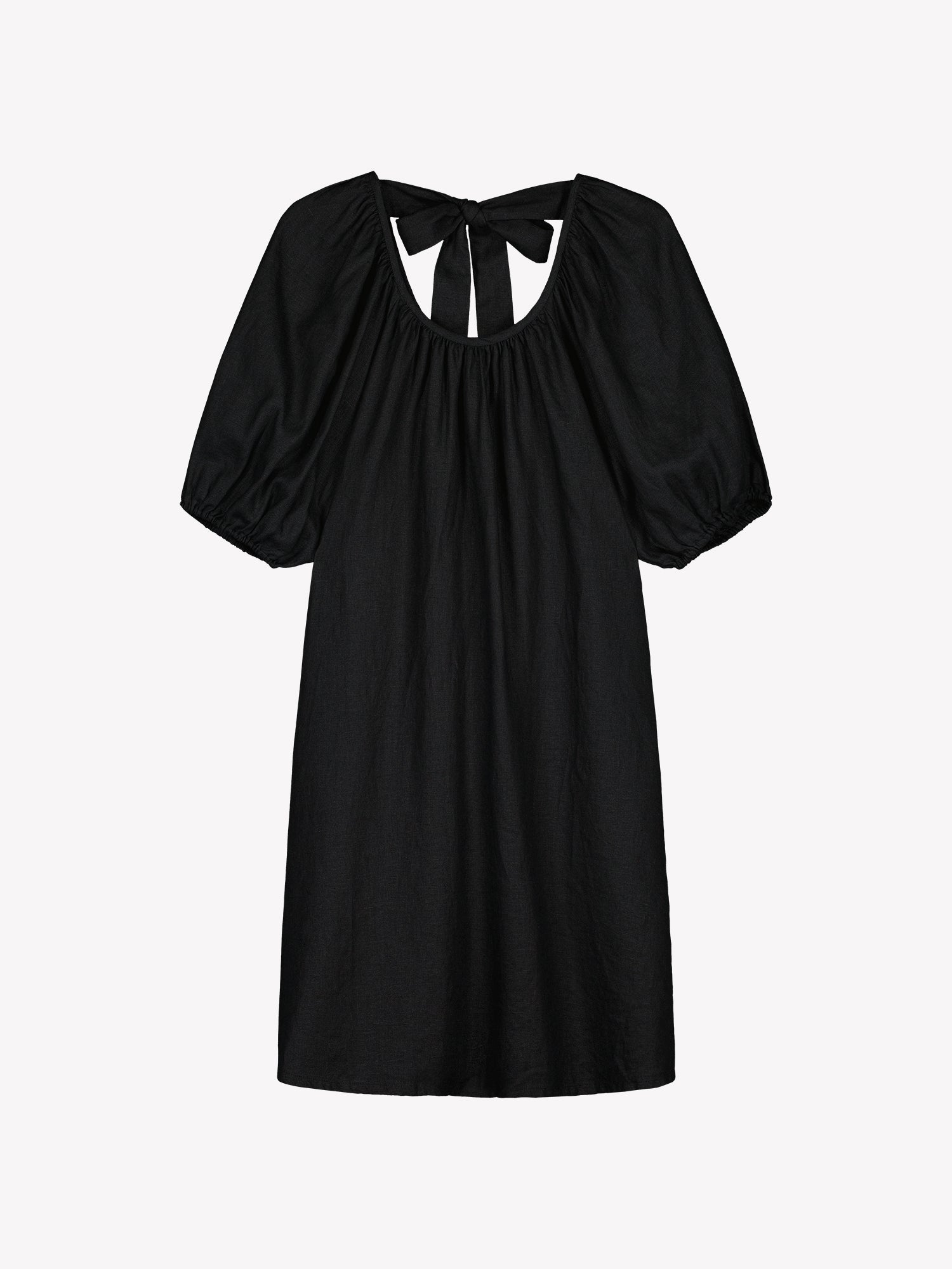 Nanso women’s beautifully relaxed black Donna linen dress. This airy short dress features a softly gathered open back neckline, finished with a tie-back bow detail. In a product picture.