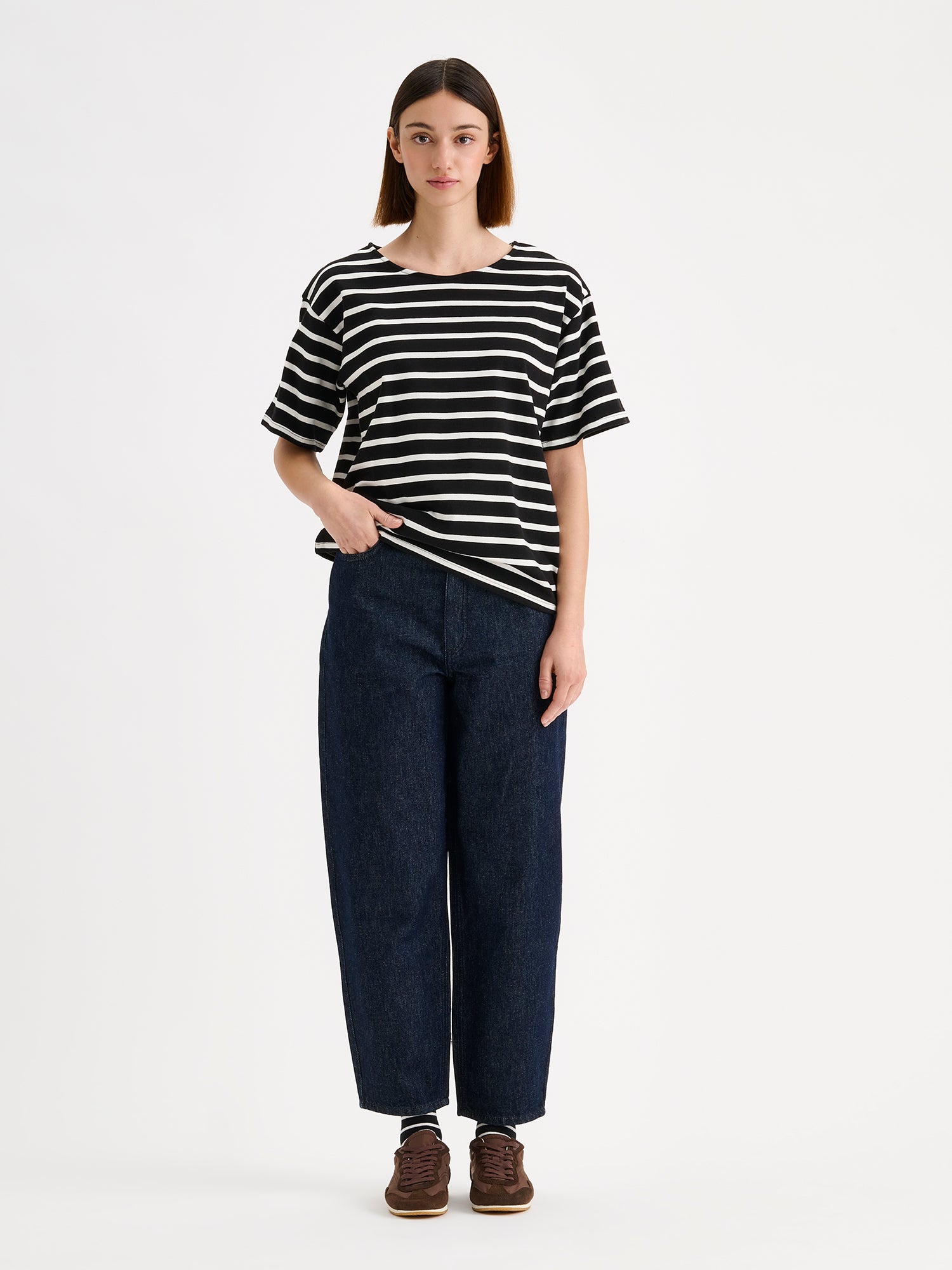 Nanso timeless black striped short-sleeved Breton T-shirt, on a model with dark blue barrel jeans.