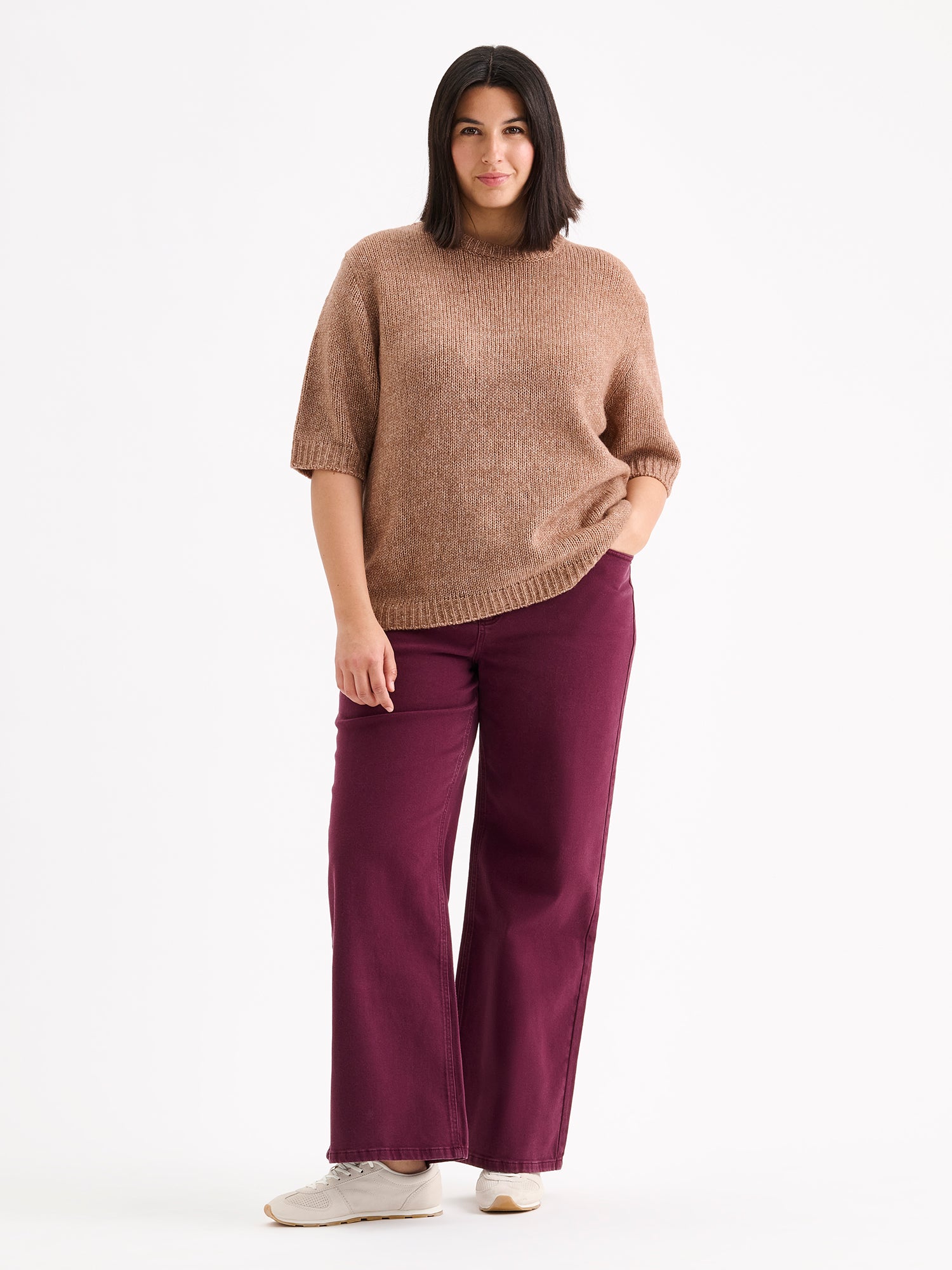 Nanso womens knit sweater Moriko in warm brown, on a model with red jeans