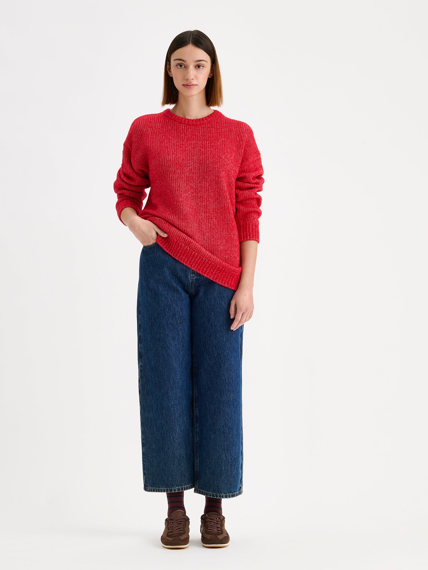 Women's relaxed long-sleeved MORIKO sweater in vibrant red shade, on a model with barrel leg jeans