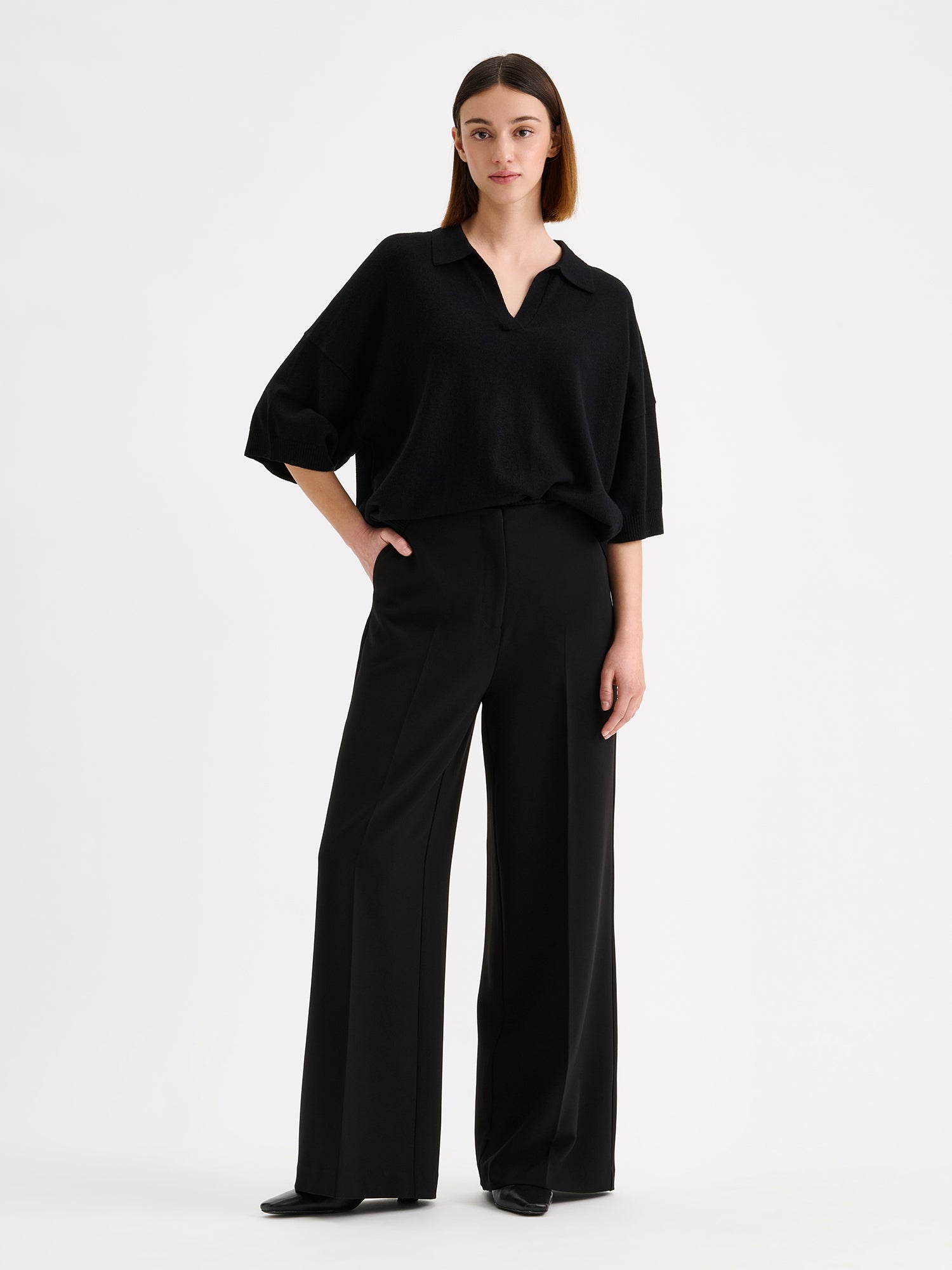 Nanso women's black, timeless Villis knit sweater with collar details, on a model with black trousers | S - 173cm