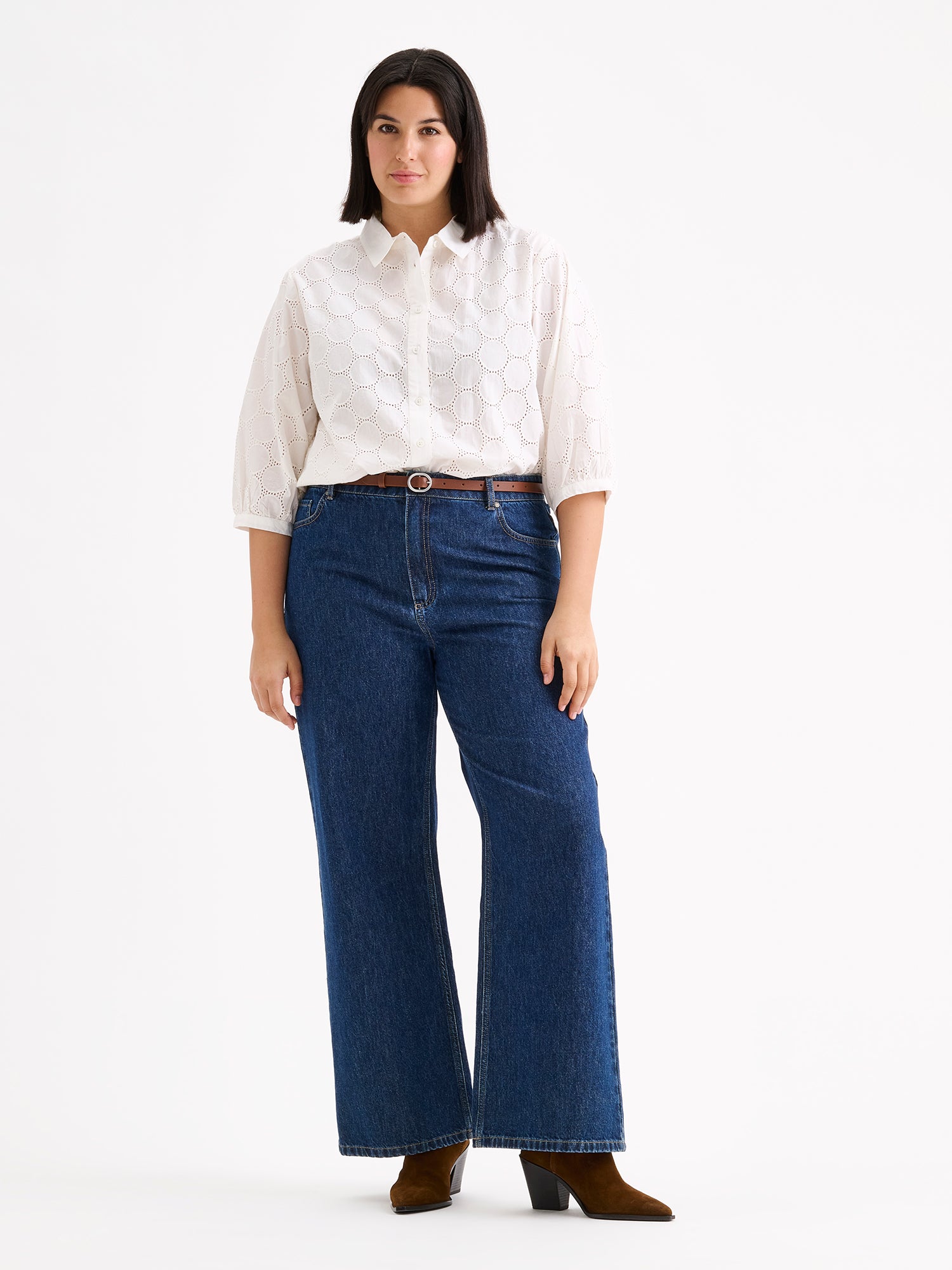 nanso women's stylish white Siiri blouse for women, featuring beautiful embroidered fabric, classic collar, buttons and 3/4 sleeves, on a model with wide blue jeans