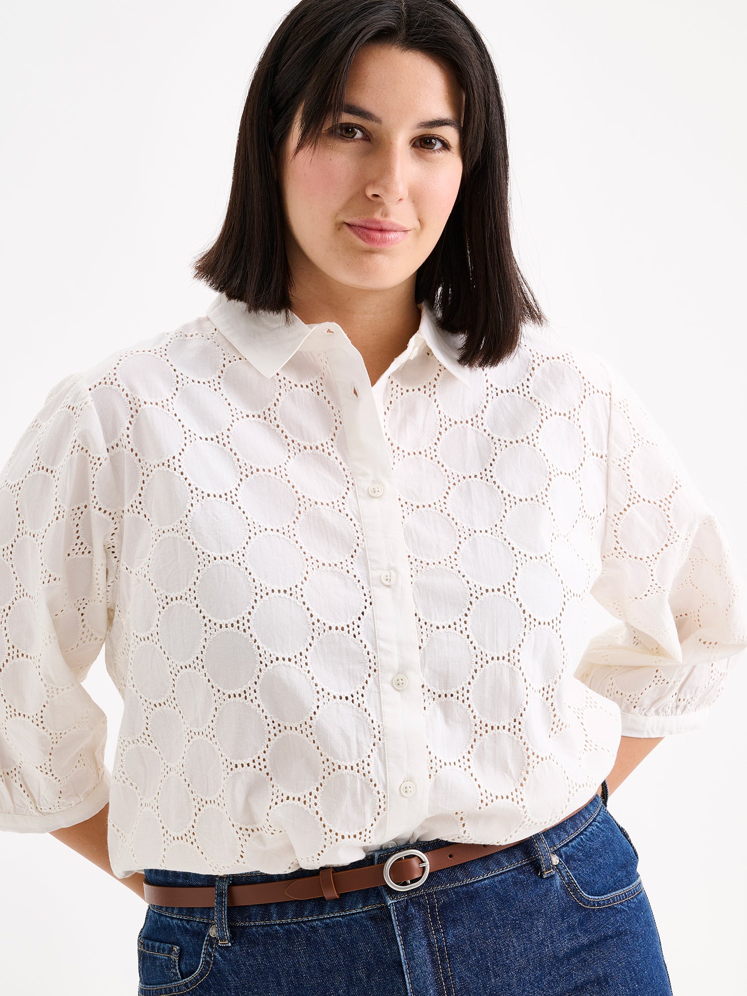 nanso women's stylish white Siiri blouse for women, featuring beautiful embroidered fabric, classic collar, buttons and 3/4 sleeves, on a model with blue jeans