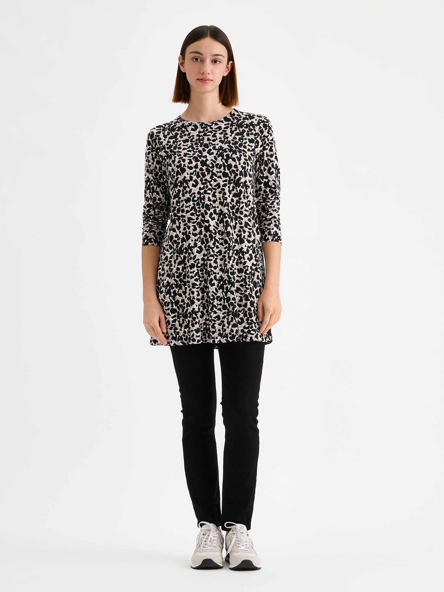 Nanso women's A-line jersey tunic in a sophisticated black-beige pattern on a model with black leggings and sneakers