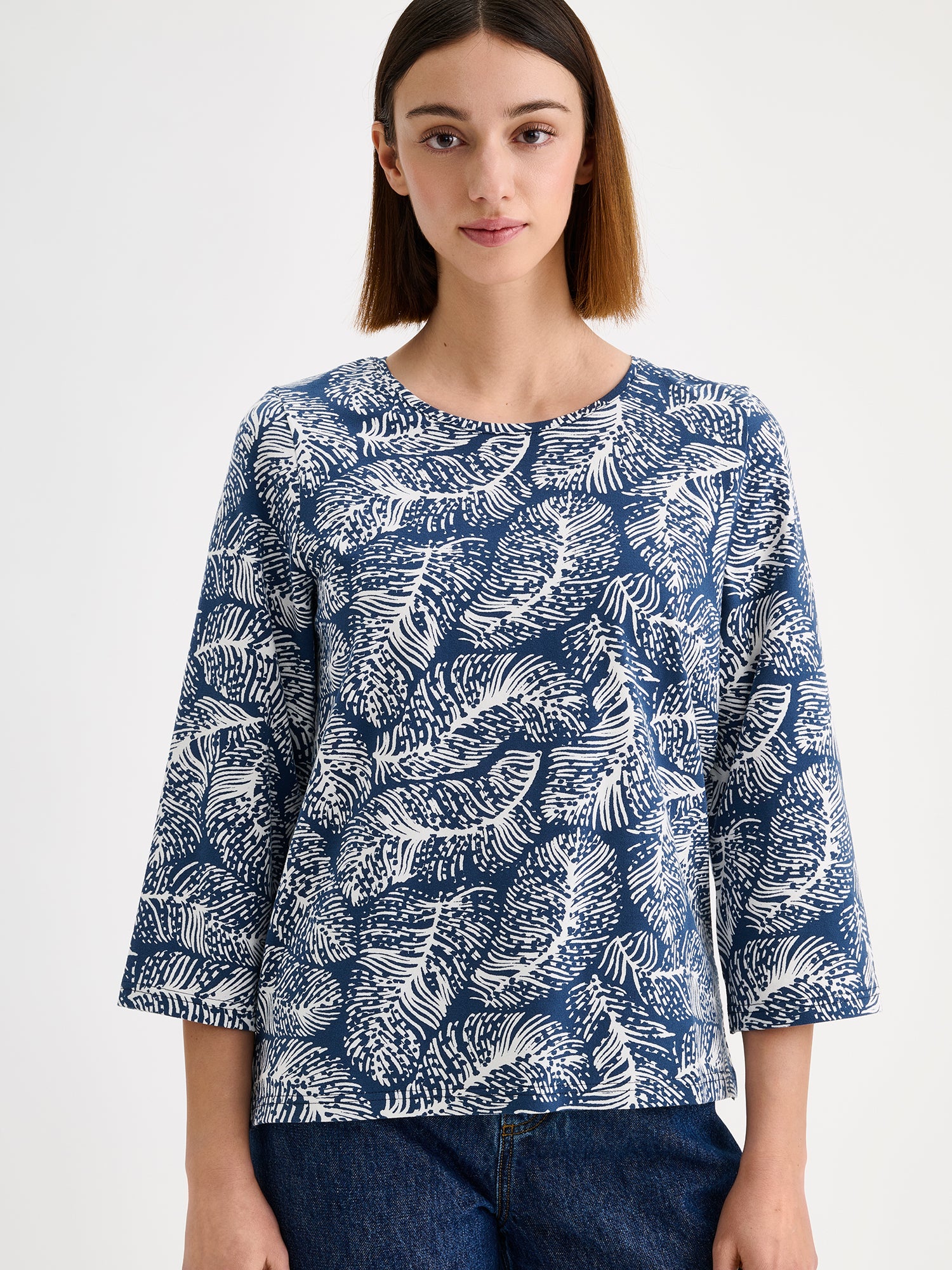 Nanso women's patterned Pieni Hilde jersey blouse is stylish and clean-lined in design with 3/4 sleeves, small side slits and a round neckline. Pictured on a model with jeans, close-up
