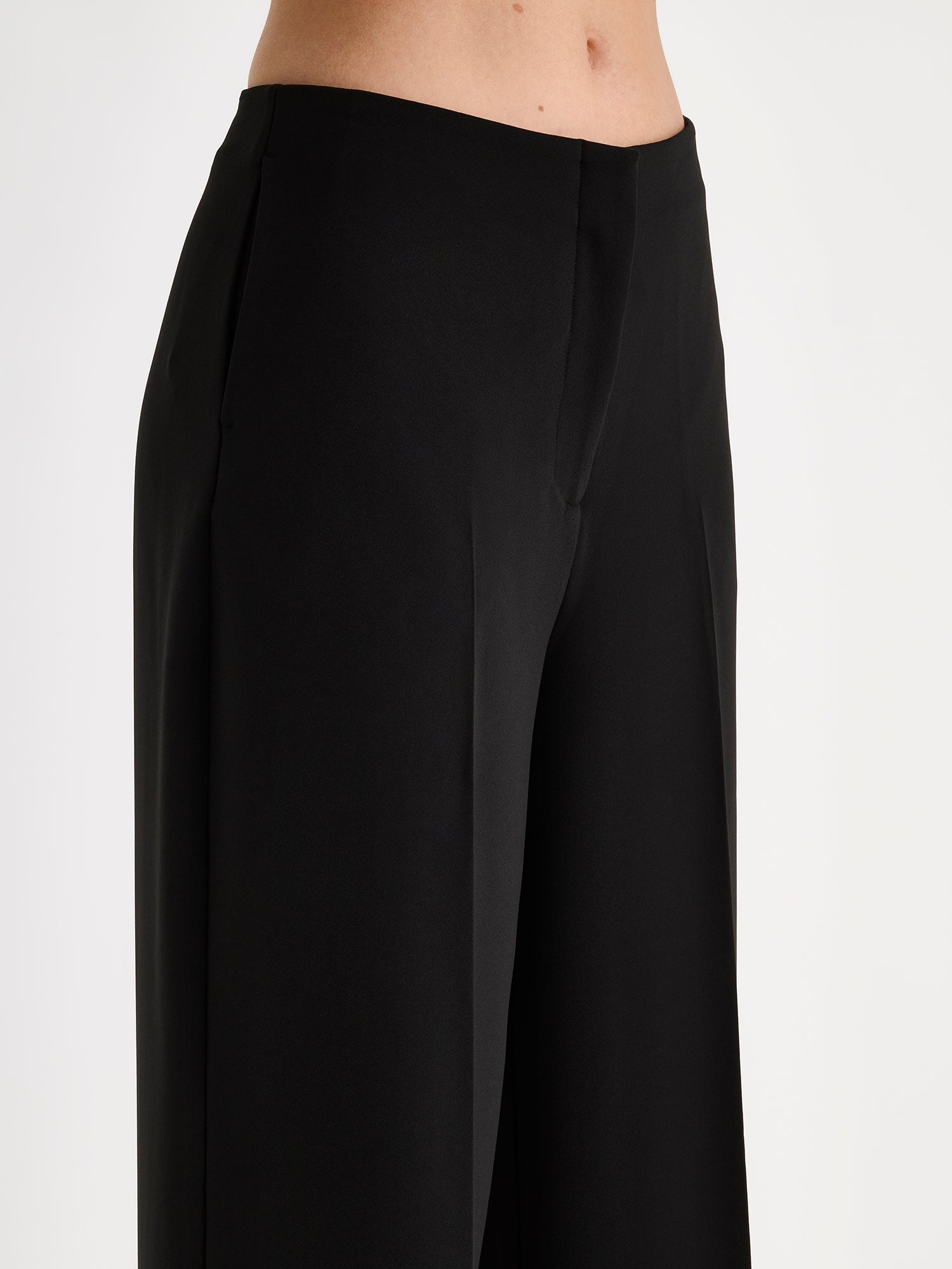 Nanso womens elegant and timeless wide-leg EEVA trousers in timeless black, on a model close-up