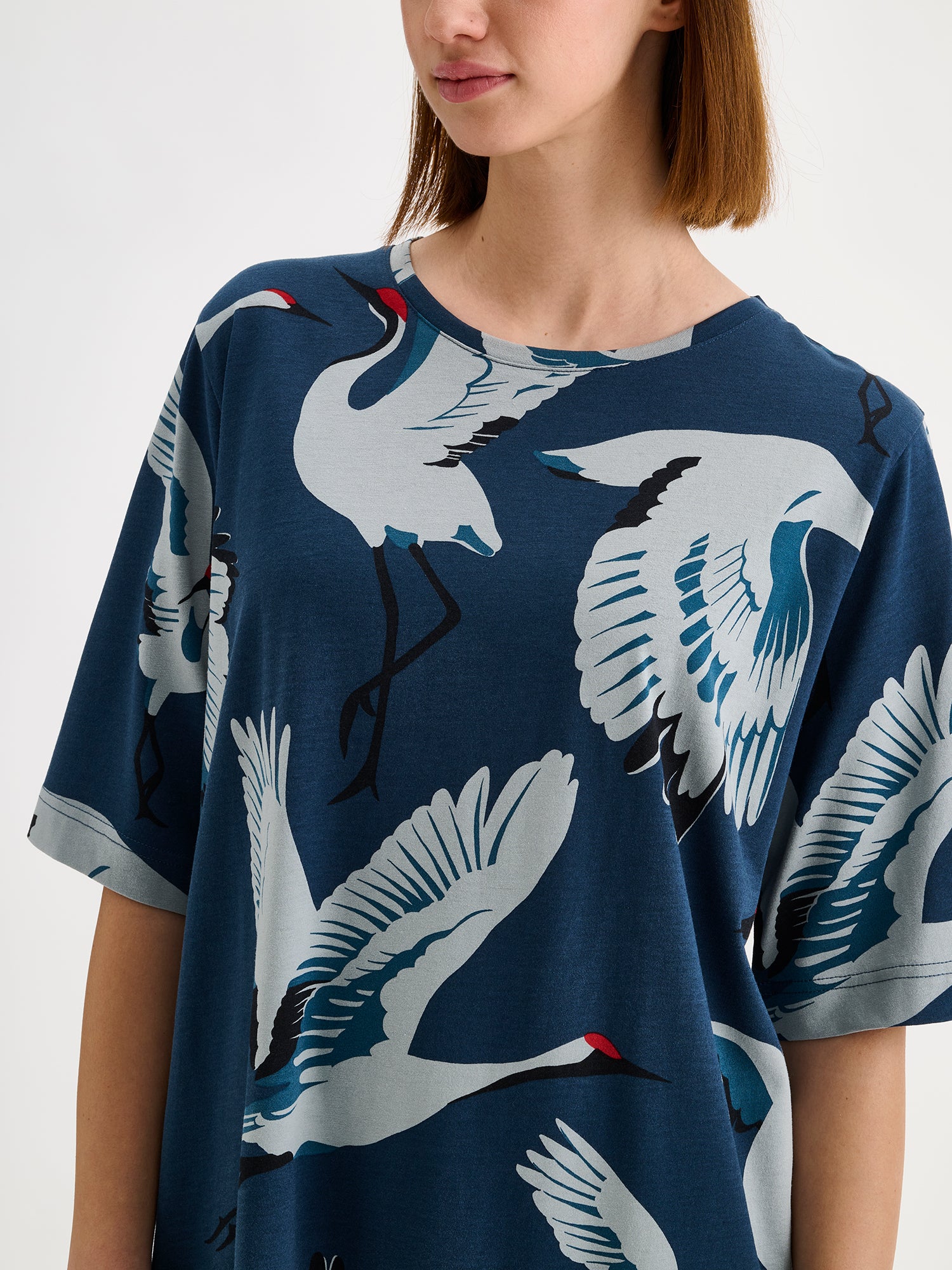 Nanso women's patterned straight-cut short nightgown in captivating blue tones on a model, close-up.