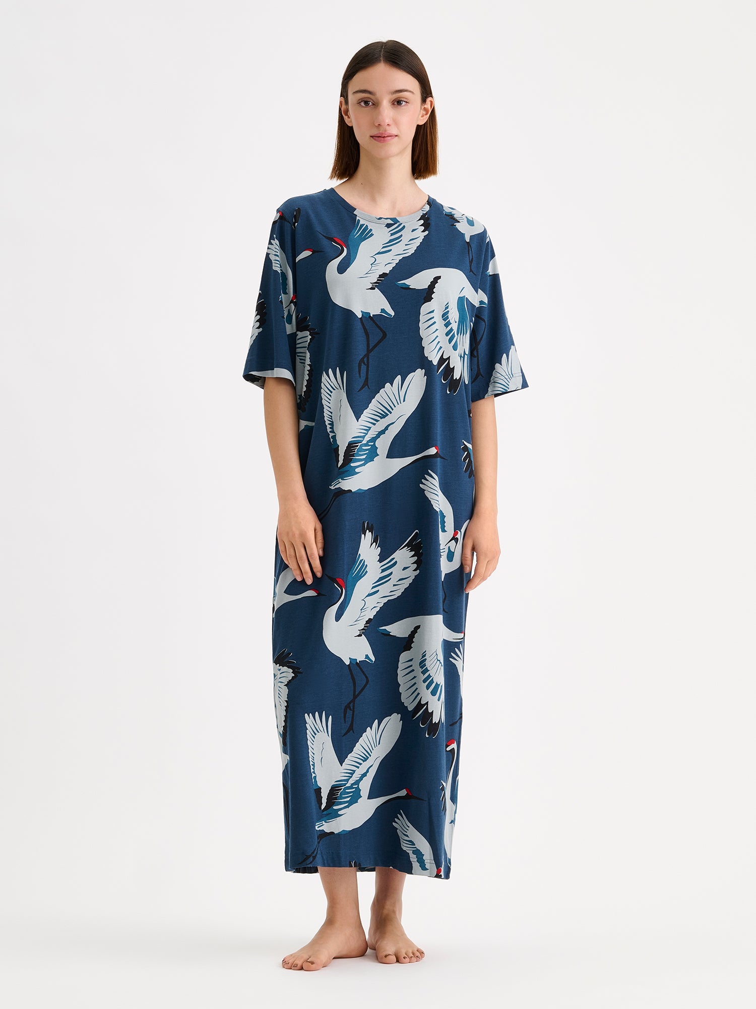 Nanso women's long straight-cut Kurki nightgown captivates with its striking blue-toned pattern. This soft and comfortable classic is perfect for relaxed evenings at home. Pictured on a model.