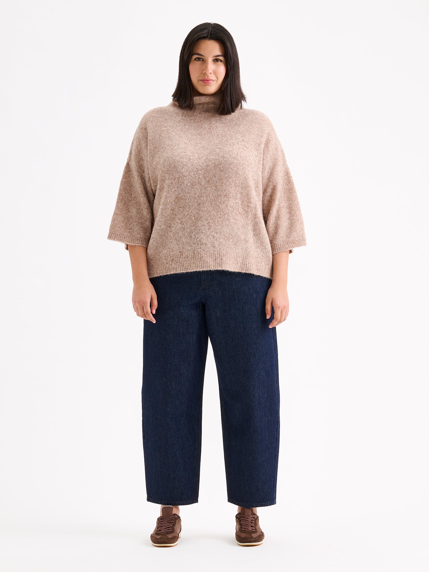 Nanso women's relaxed Alina knit sweater with a high neckline on a model with blue jeans