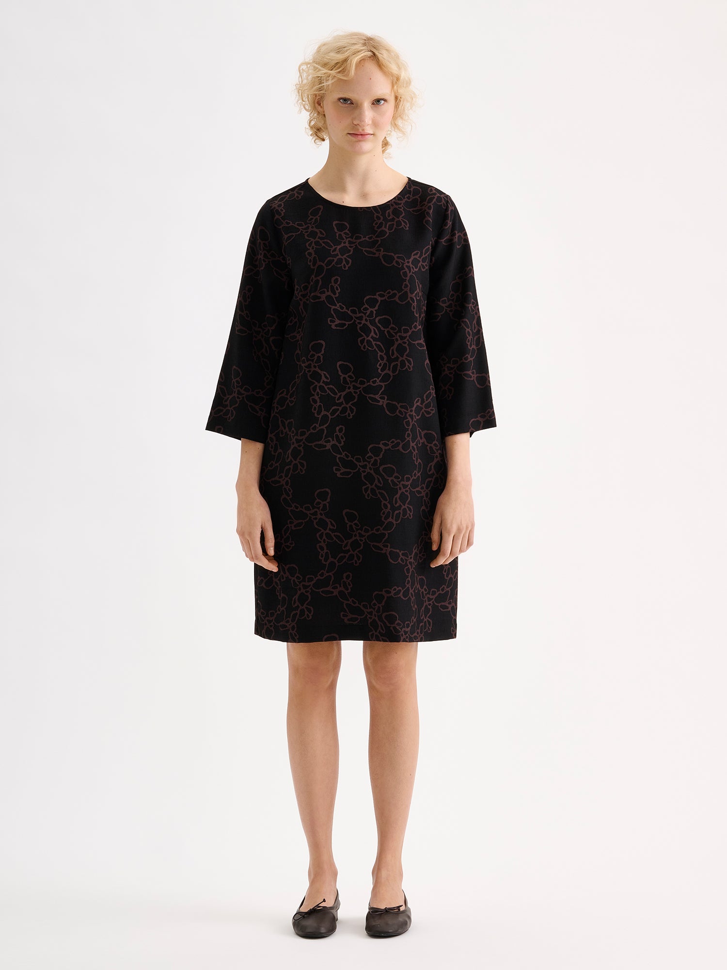 Nanso womens straight-cut woven dress for women featuring a harmonious and elegant black-brown pattern on a model with ballerinas | 36 - 177cm