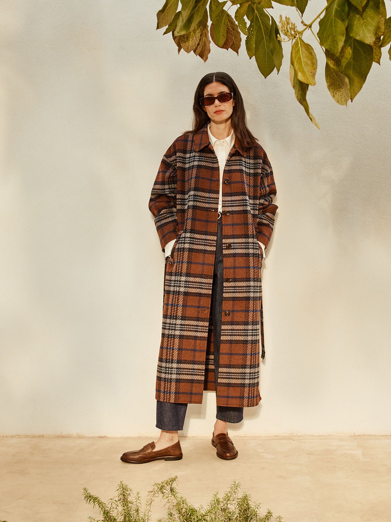 The stylish and timeless Astrid wool coat features a contemporary checked pattern, pictured on a model