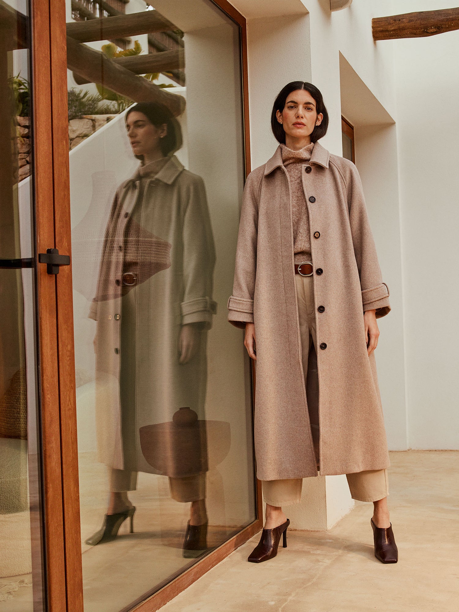 Nanso women's timelessly elegant and effortlessly classic, the Tove long wool coat in beige, on a model with a beige outfit.
