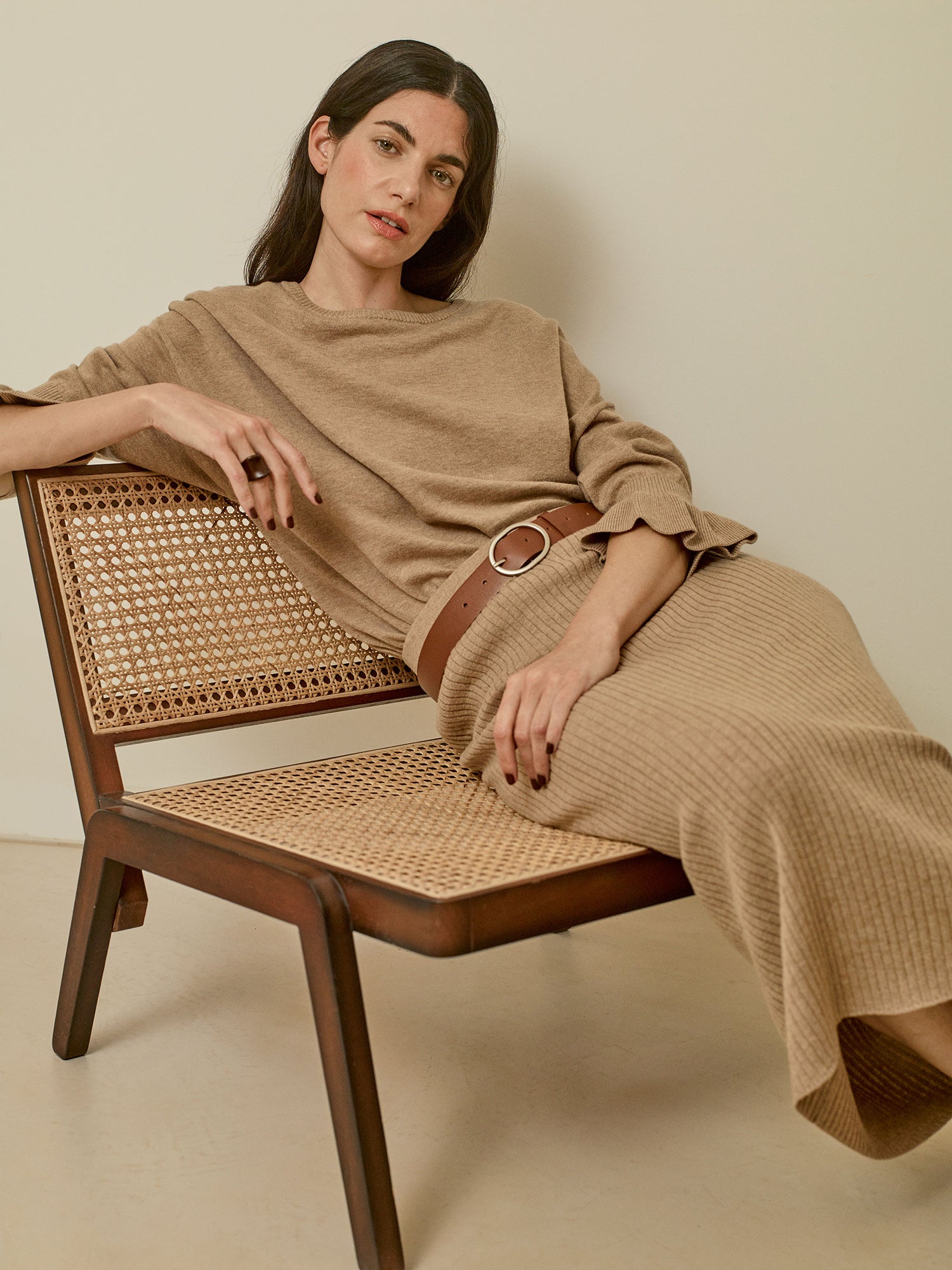 Nanso women's simply stylish and lightweight Villis Frilla knit jumper is charmingly finished with beautiful frill details at the cuffs, pictured on a model with a matching knit skirt
