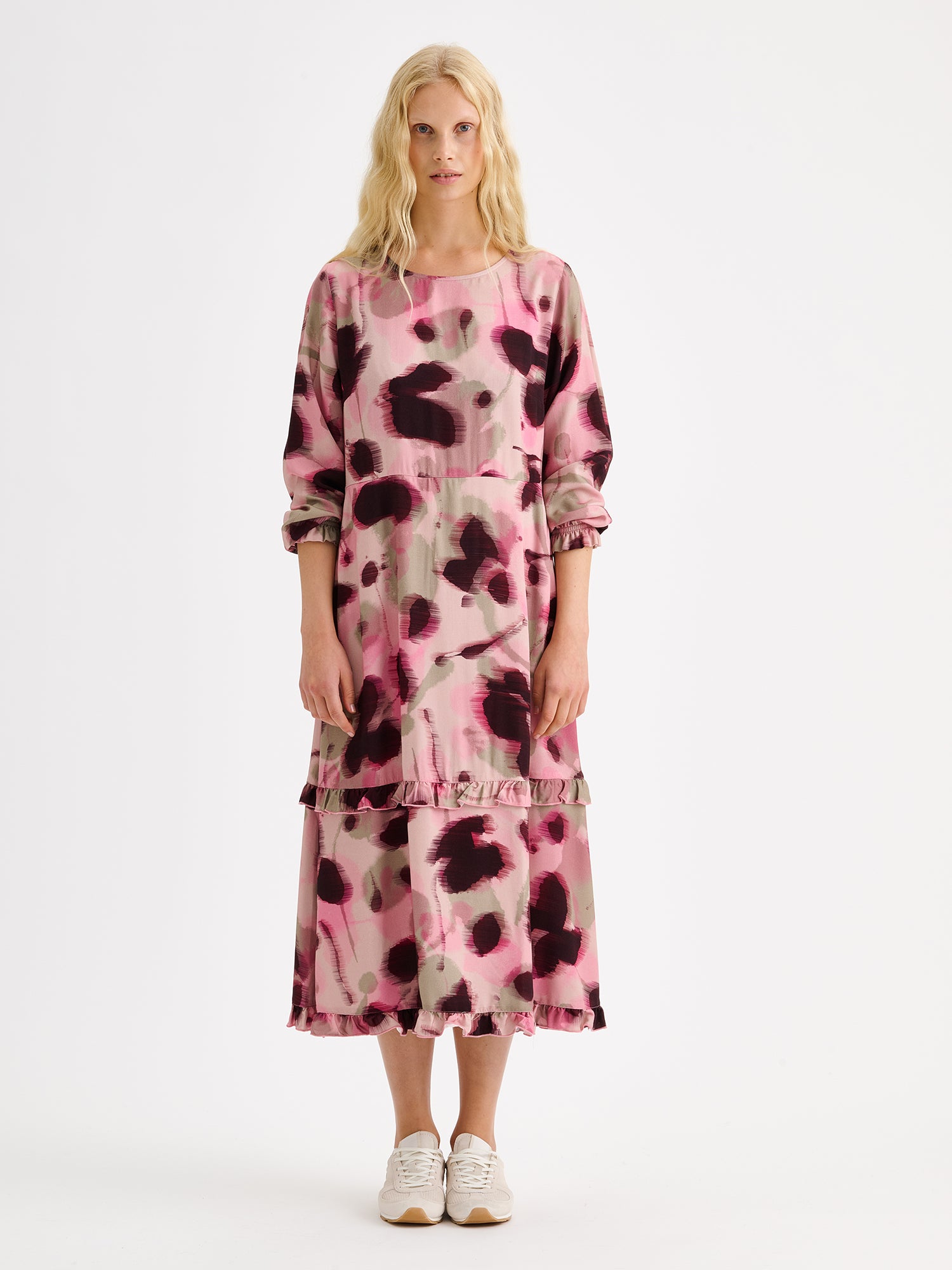 Nanso women's feminine and eye-catching Ruusu midi woven dress is adorned with a painterly print, on a model with sneakers