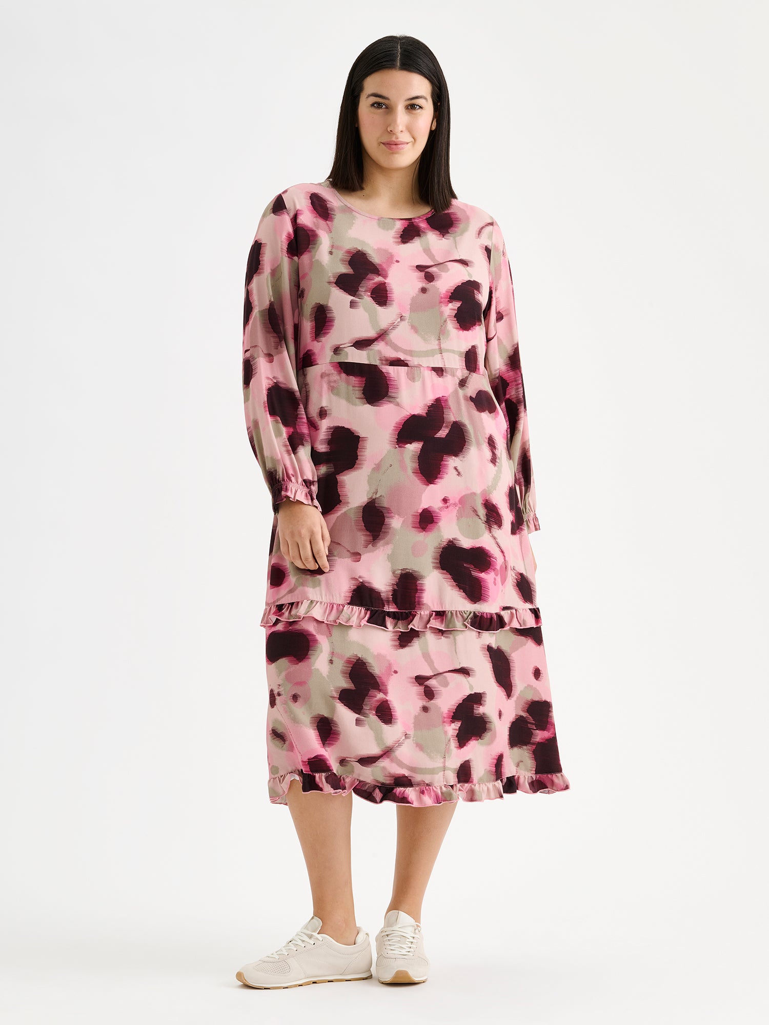 Nanso women's feminine and eye-catching Ruusu midi woven dress is adorned with a painterly print, on a model with sneakers