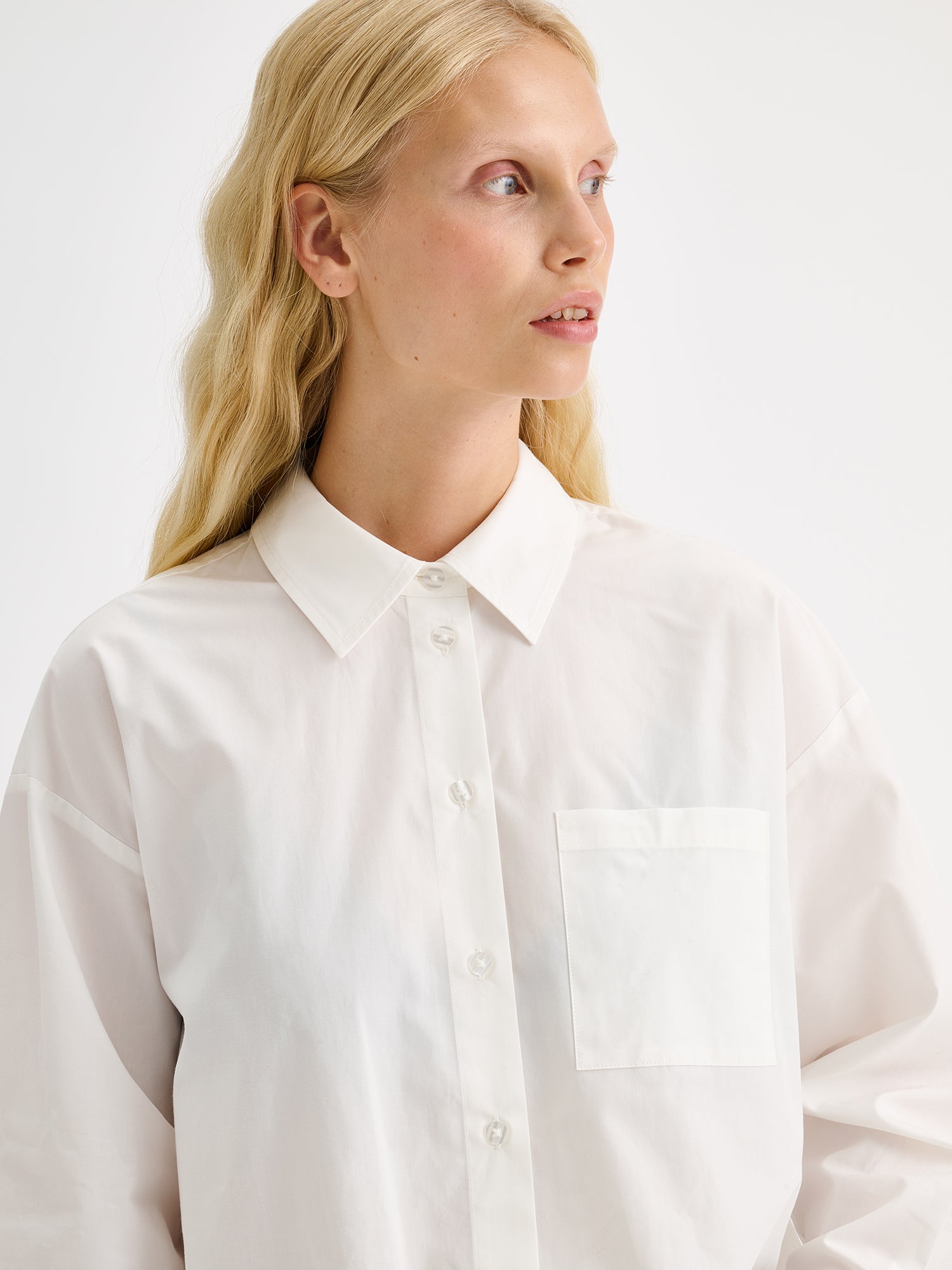 Nanso womens relaxed-fit white Sofi shirt pictured on a model, close-up.