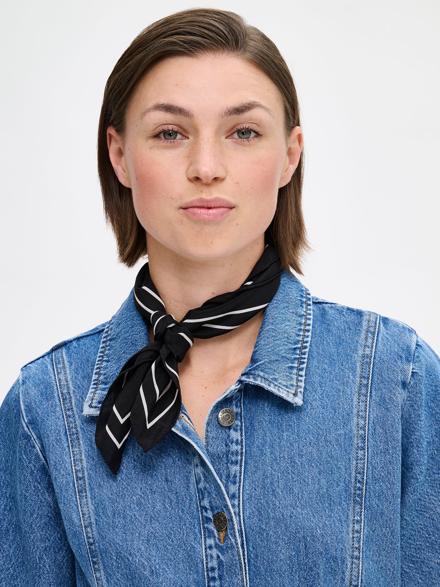 Palsta sophisticated patterned silk scarf in black and white on a model with a denim jacket