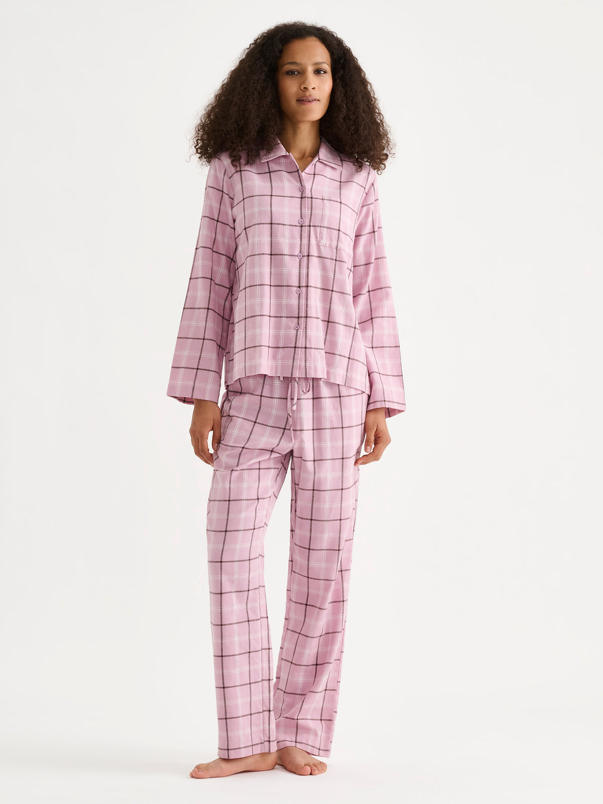 Nanso women's Tuulikki flannel pyjama shirt and pants in pink on a model. | S - 180cm
