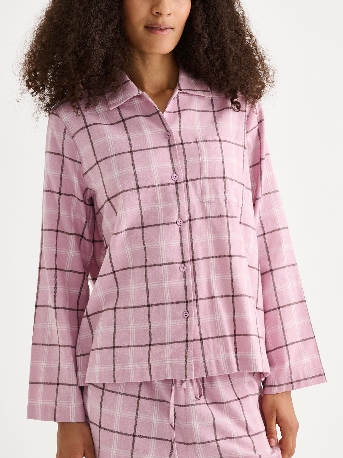 Nanso women's Tuulikki flannel pyjama shirt and pants in pink on a model. | S - 180cm