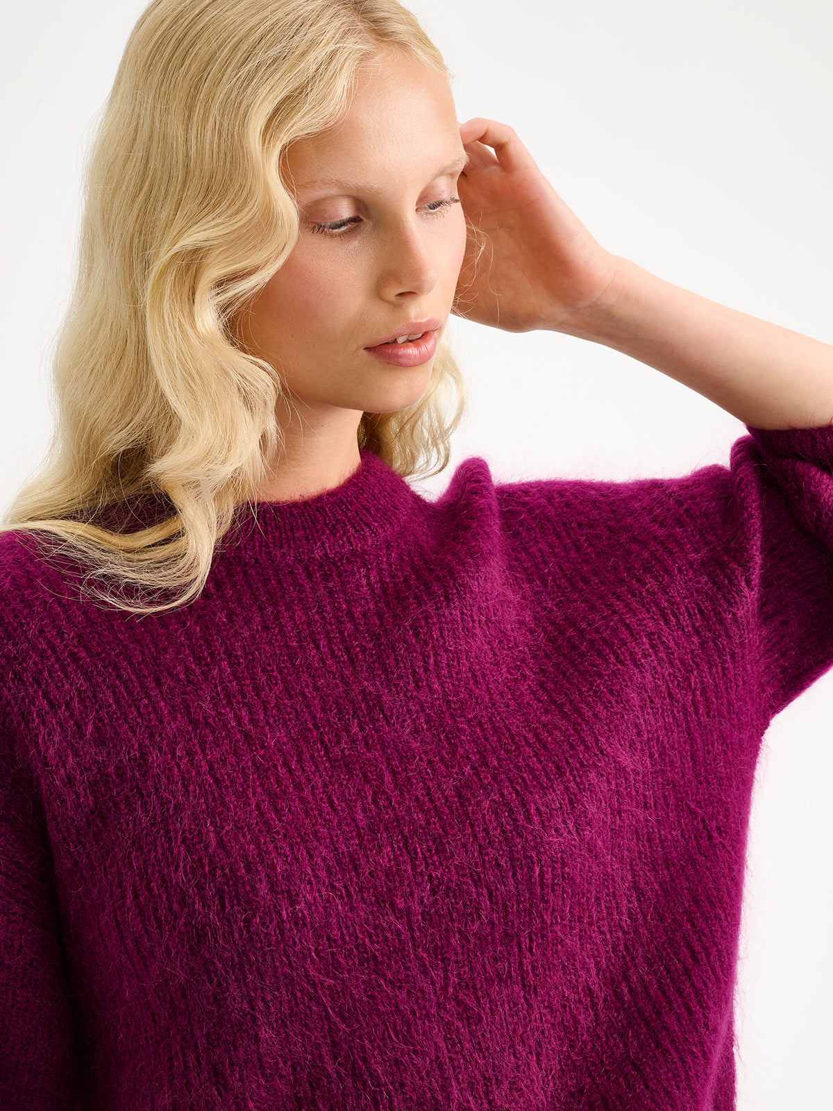 Nanso women's wonderfully warm and luxurious Sumi knitted sweater in vibrant violet and beautifully fluffy texture, on a model close-up.