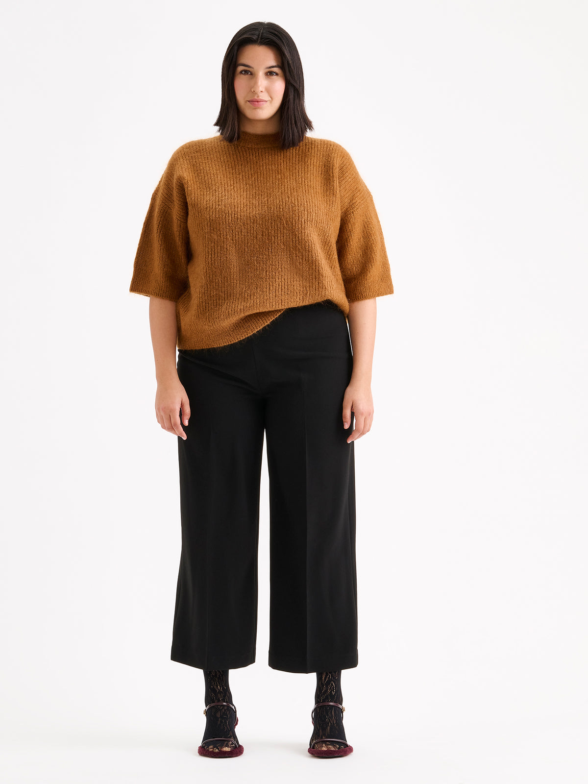 Nanso women's wonderfully warm and luxurious Sumi knitted sweater in rich brown and beautifully fluffy texture, on a model with black trousers.