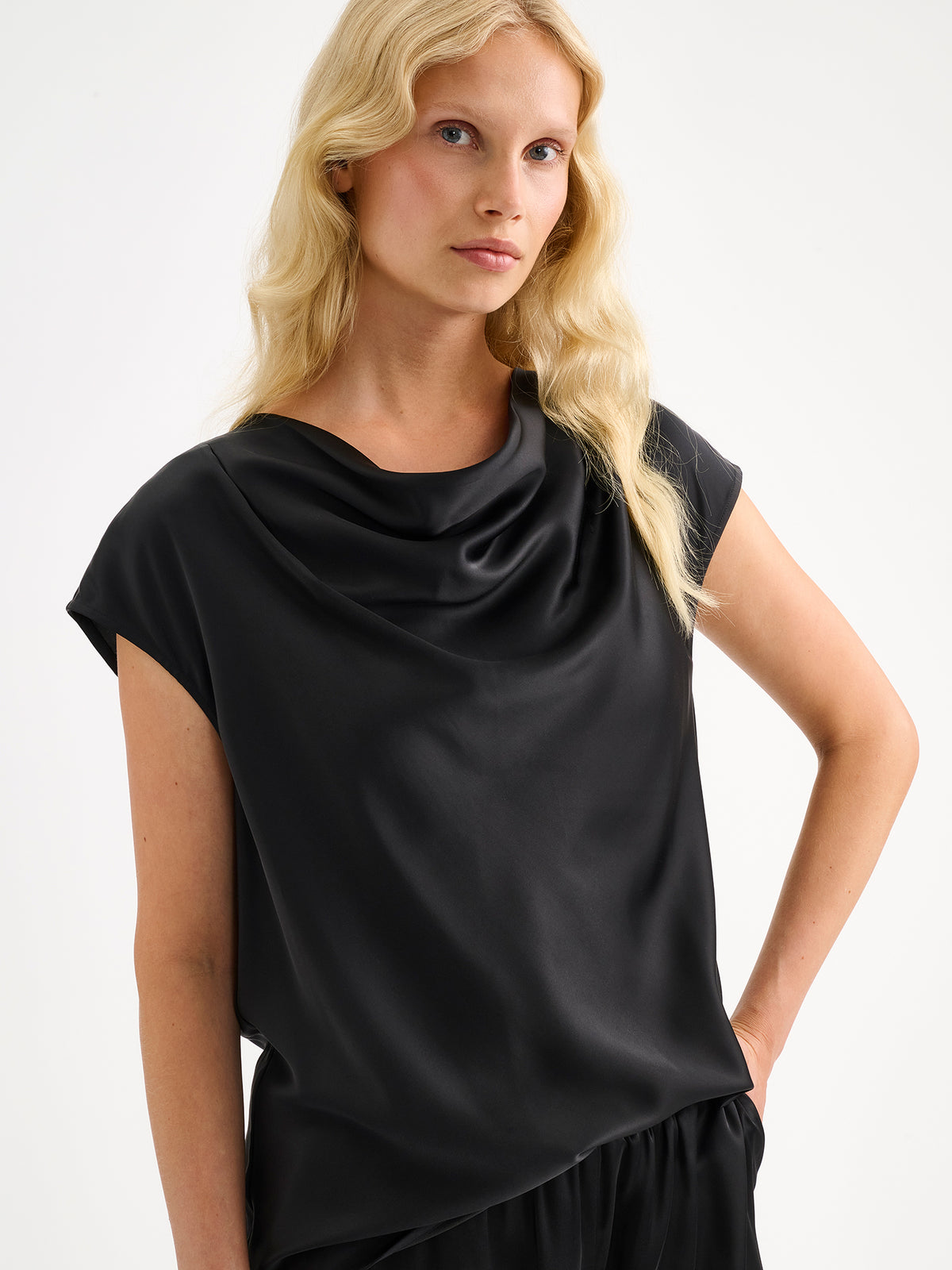 Nanso women's elegant Silva satin blouse in a classic black shade on a model with matching satin trousers.