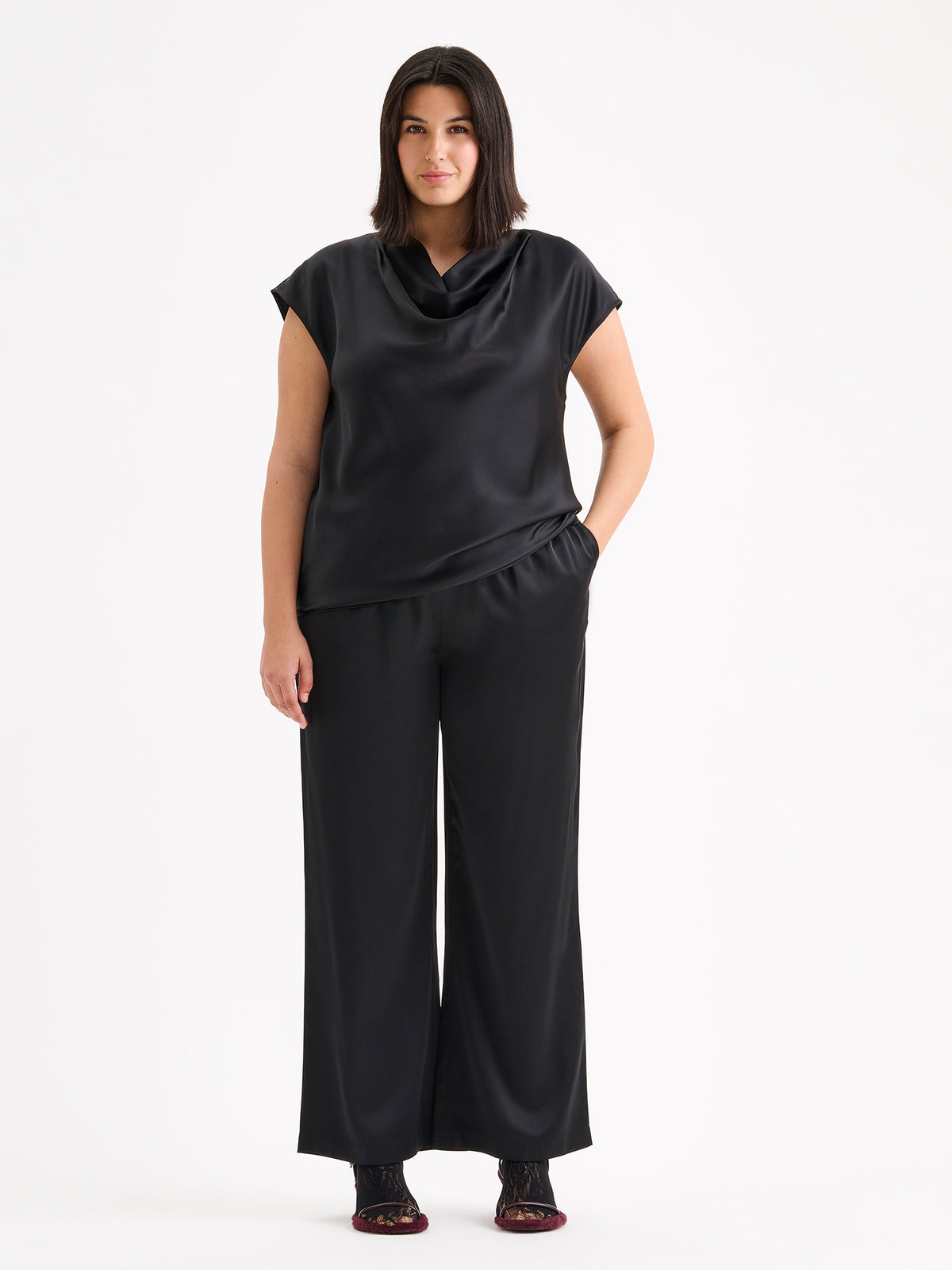 Nanso women's elegant Silva satin blouse in a classic black shade on a model with matching satin trousers.