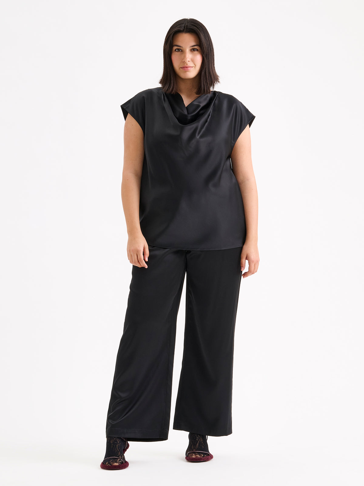 Nanso women's elegant Silva satin blouse in a classic black shade on a model with matching satin trousers.
