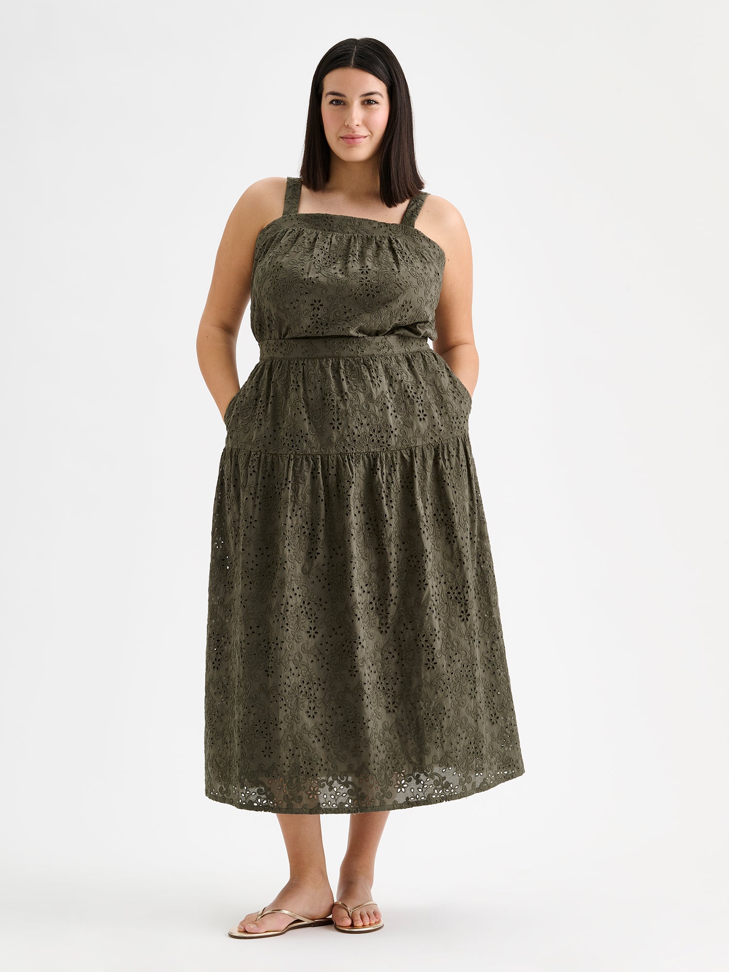 Nanso women's Odette skirt is a beautiful maxi-length skirt with a flowing silhouette, crafted from olive green cotton fabric featuring delicate broderie anglaise detailing, on amodel with a matching top.