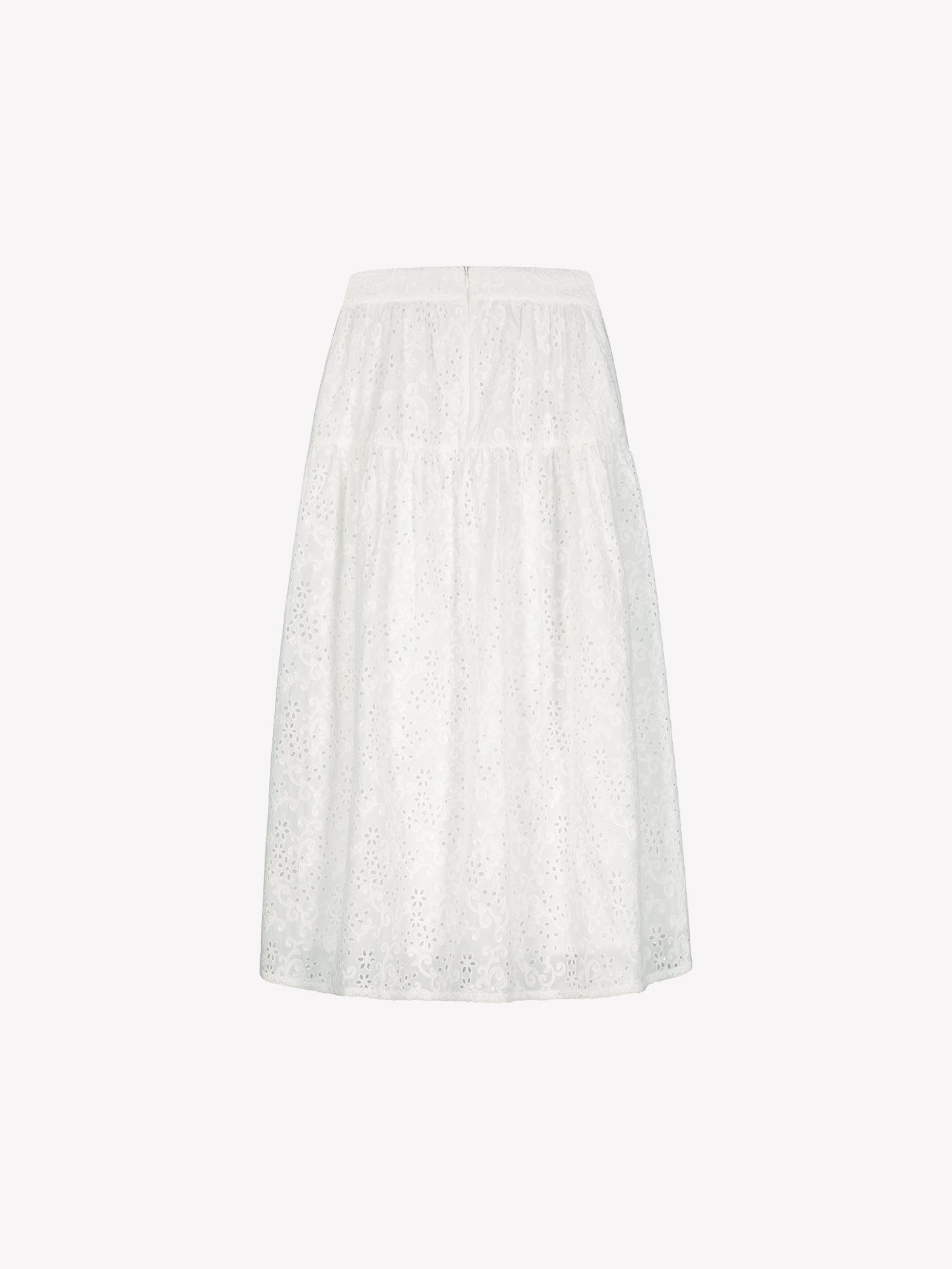 Nanso women's Odette skirt is a beautiful maxi-length skirt with a flowing silhouette, crafted from soft white cotton fabric featuring delicate broderie anglaise detailing, in a product picture, pictured from the backside.