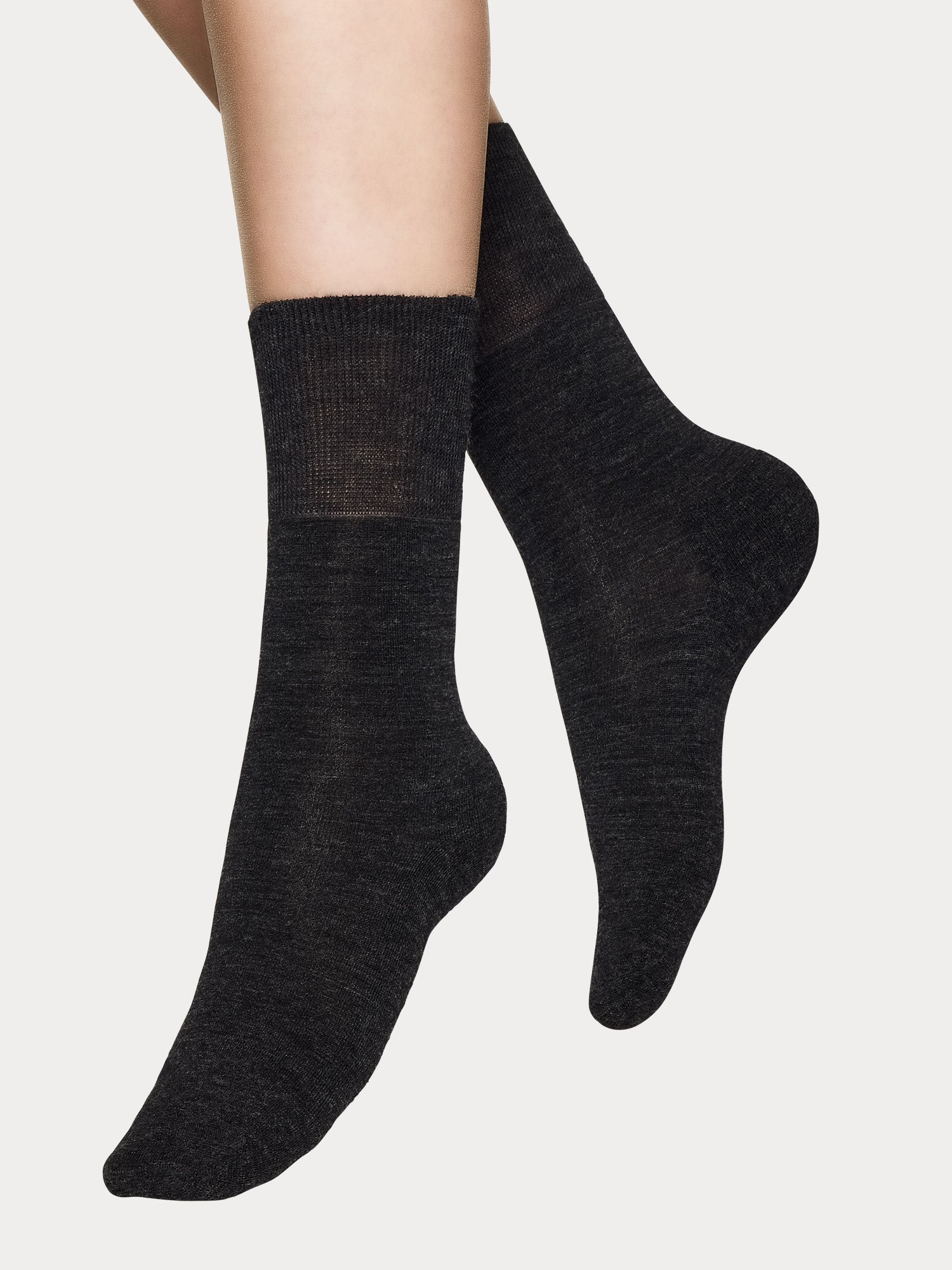 Vogue women's melange gray merino wool ankle socks with soft terry sole and seamless toe construction, pictured on a model.