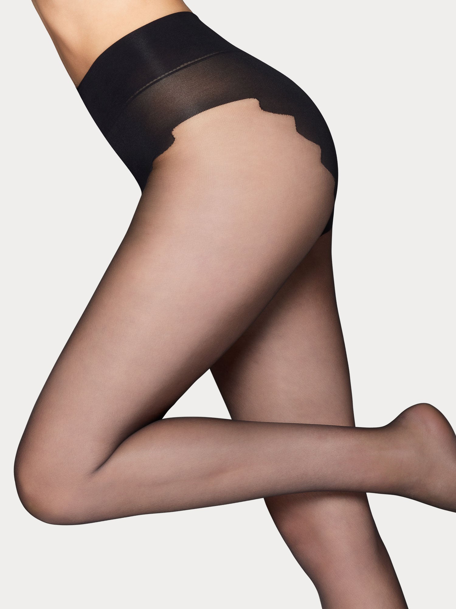 Vogue Sensual Shape 15 denier light shaping black tights with a soft powdery finish and a light shaping bikini panty, on a model.