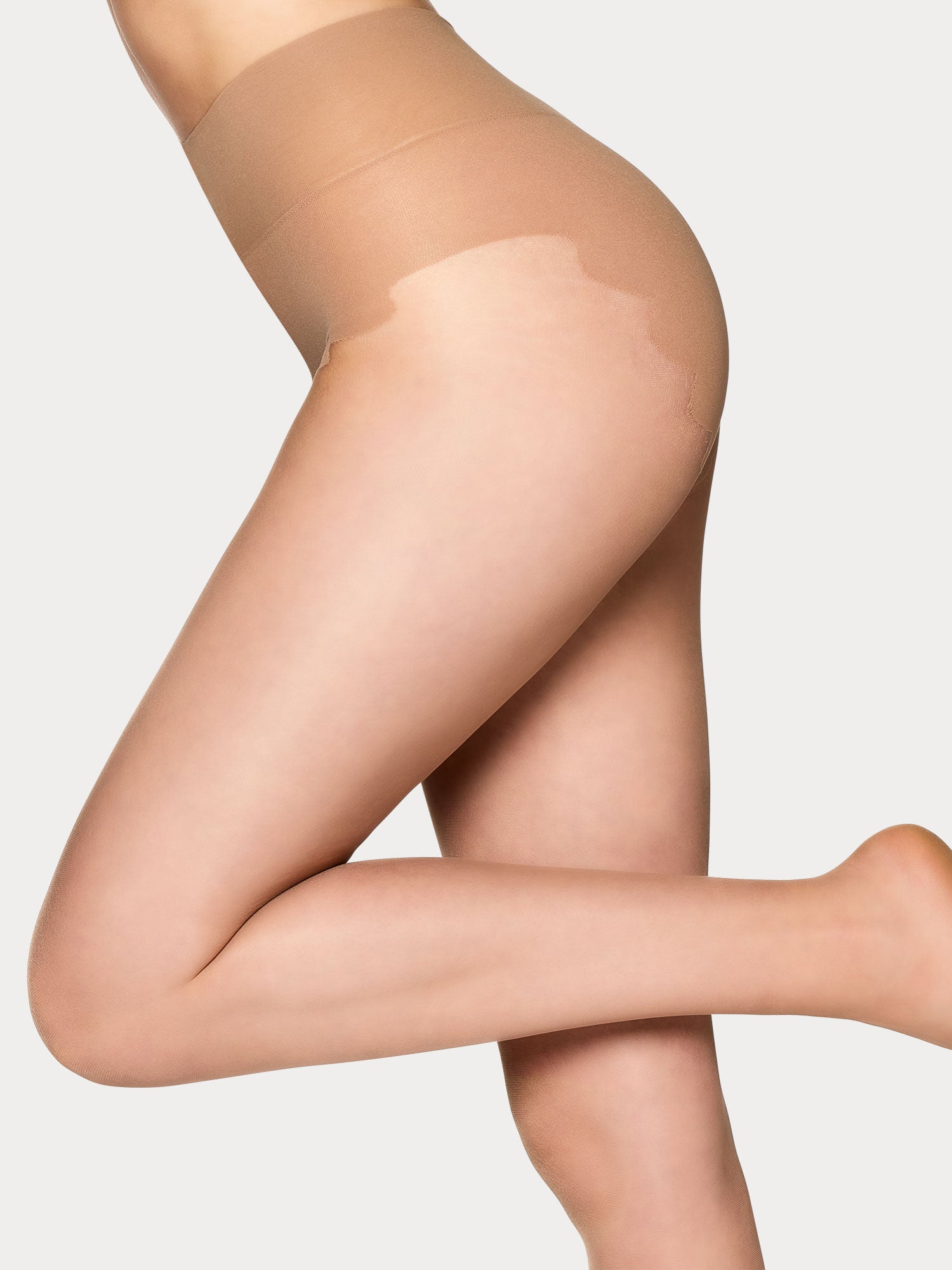 Vogue Sensual Shape 15 denier light shaping natural tights with a soft powdery finish and a light shaping bikini panty, on a model.