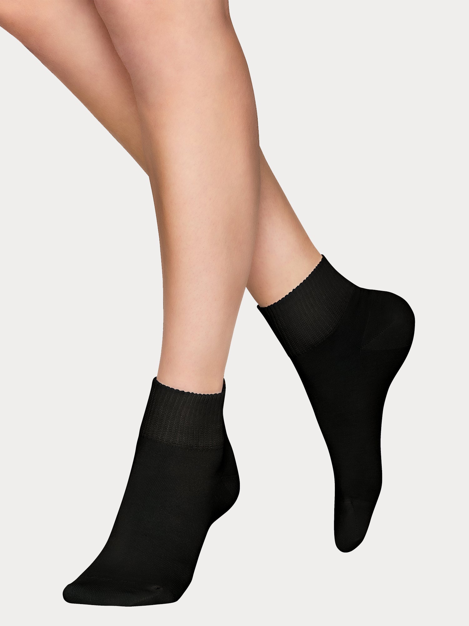 Vogue women's Lyocell Sneaker socks are crafted from sustainable lyocell. The contemporary wide cuff provides a secure, comfortable fit. White pair of socks pictured on a model.