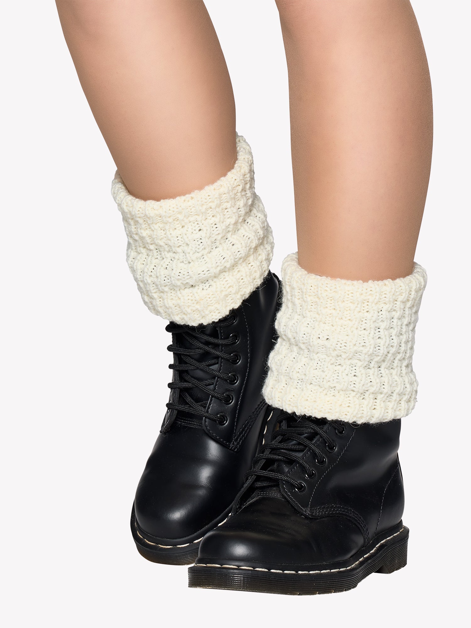 Bonnie ankle warmers paired with black boots worn by a model.