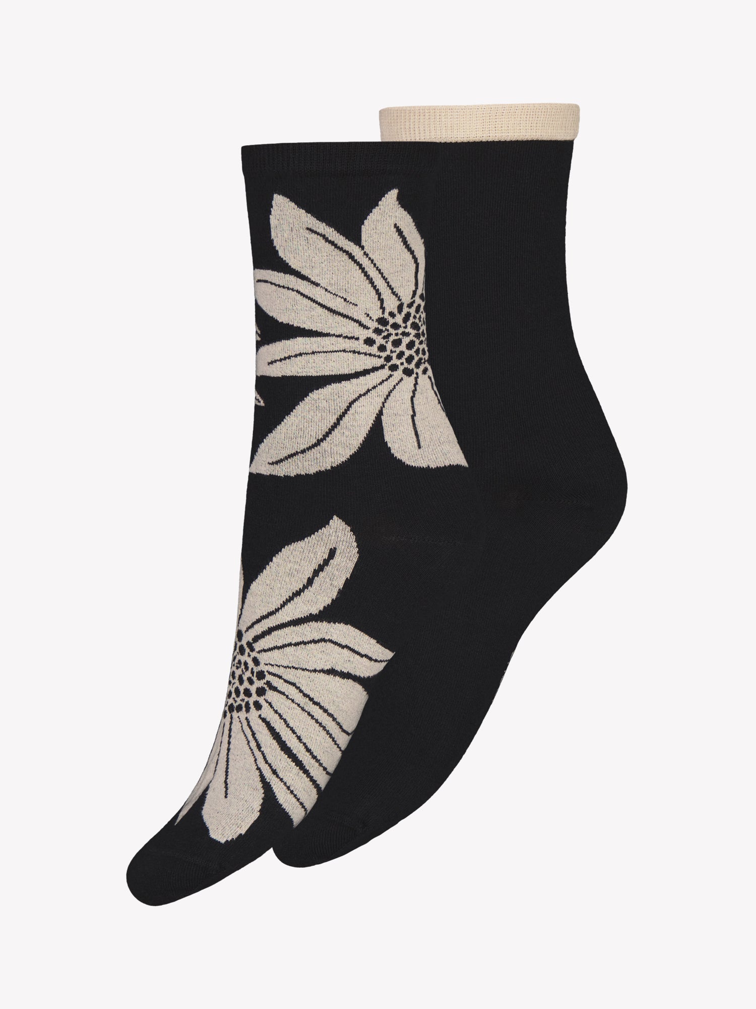 Vogue's Sylvi ankle socks shown in a product picture: one pair in black with a beige flower print, and one solid black pair with a beige cuff.