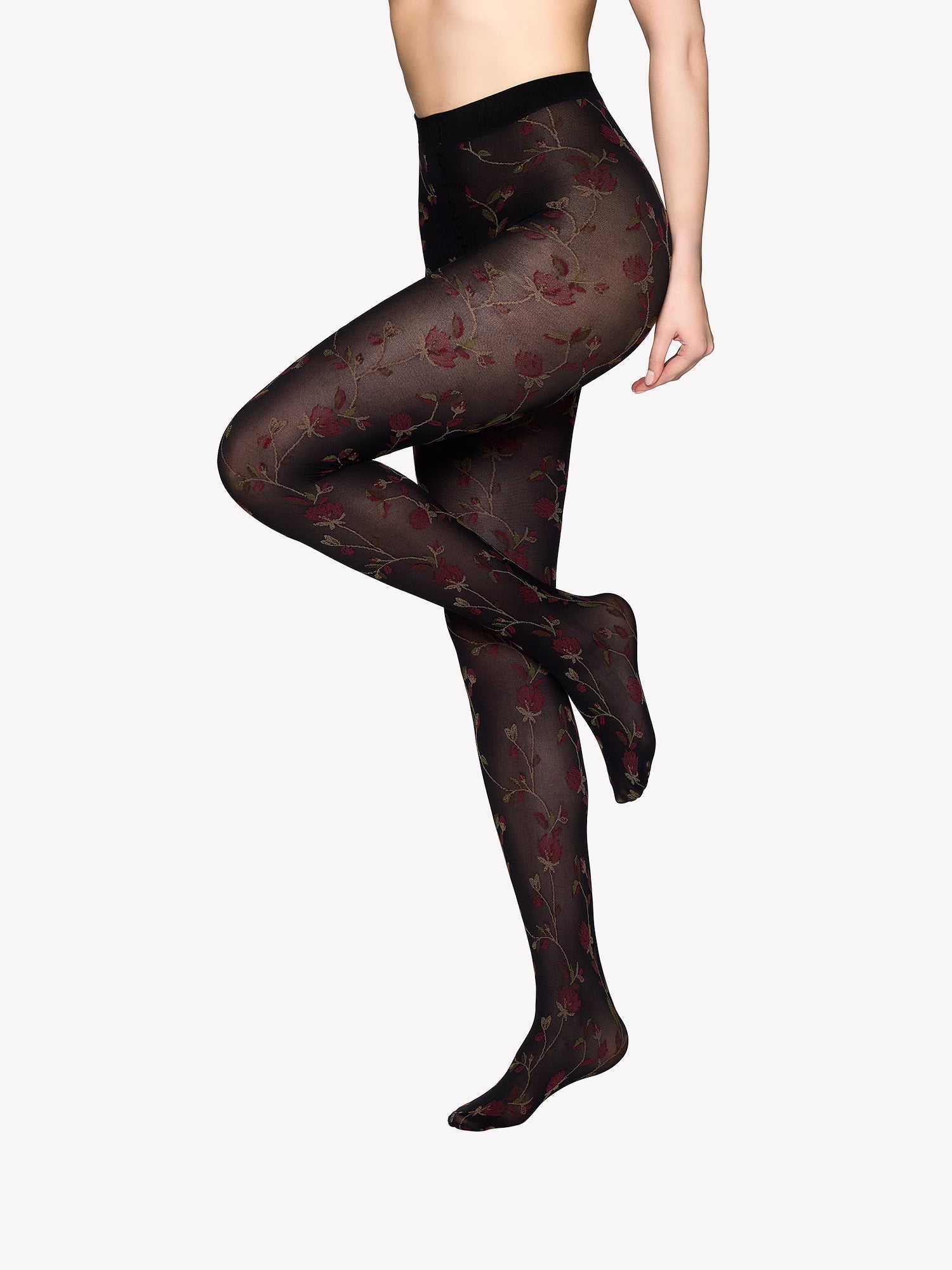 Vogue's black 50 denier matte Pamela tights with red floral details worn by the model in product image.