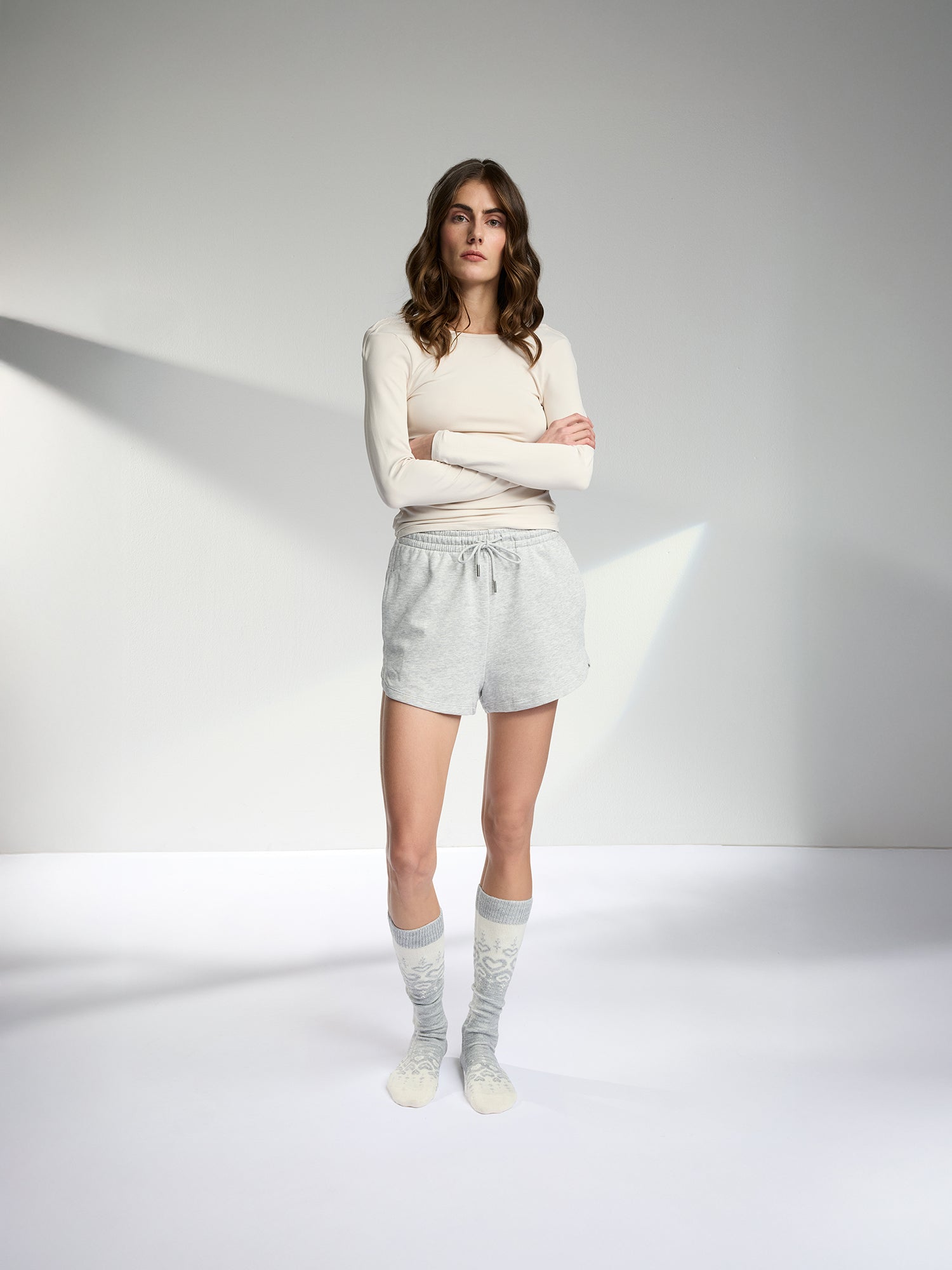 Soft grey-toned wool blend knee-high socks with a charming heart pattern, pictured on a model