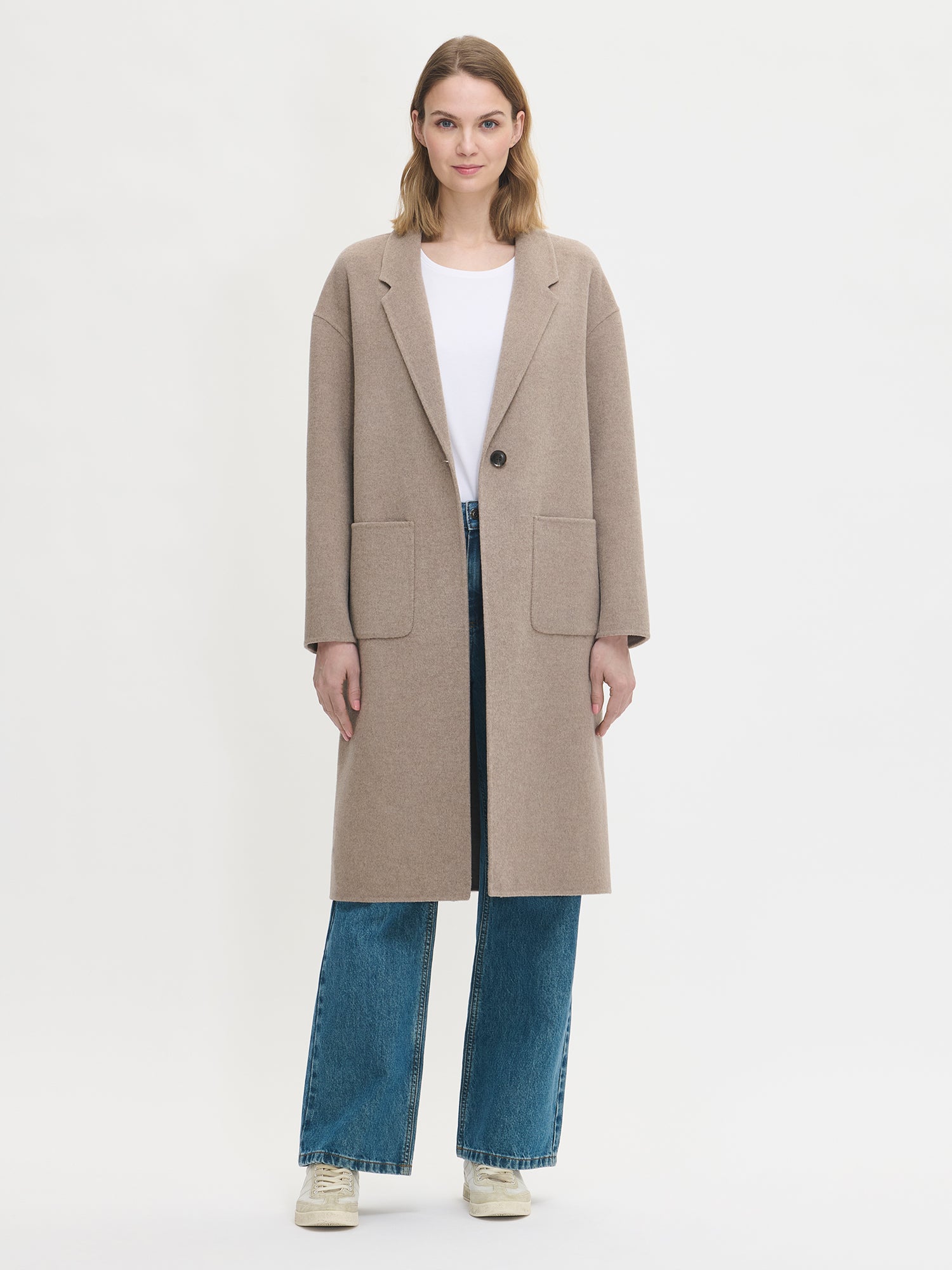 Nanso women's stylish and timeless beige YLLE wool coat. On a model from the front open