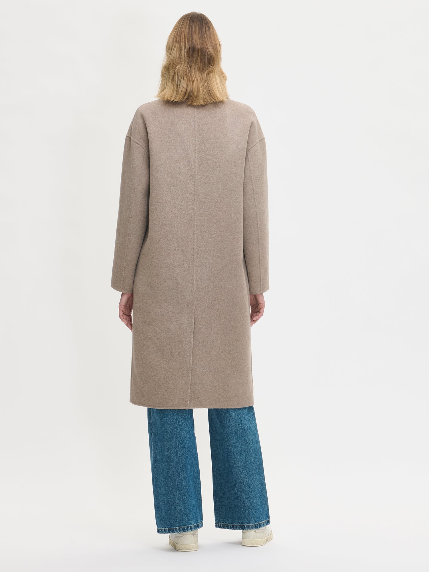 Nanso women's stylish and timeless beige YLLE wool coat. On a model from the back