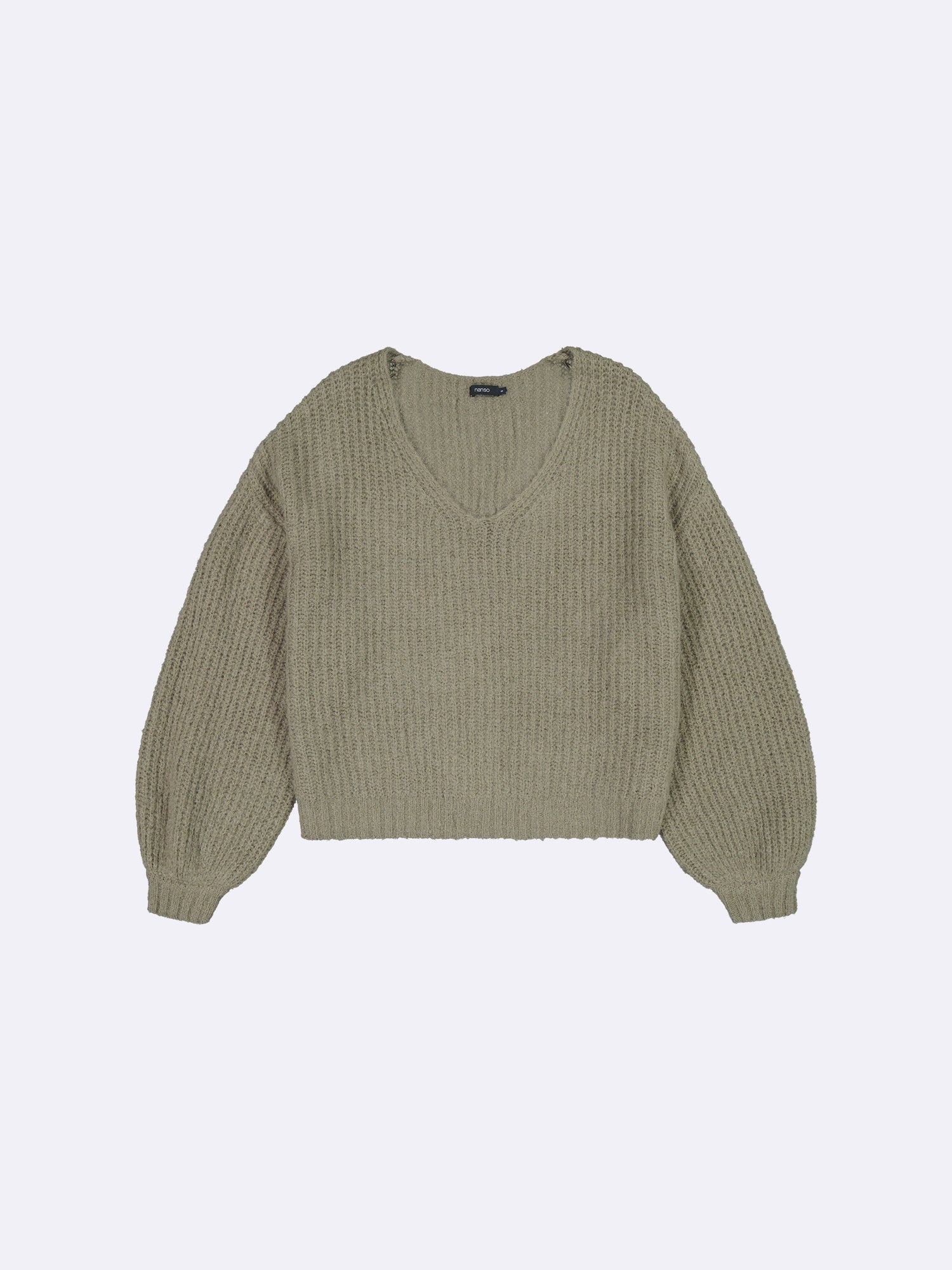 Green ribbed sweater on a light gray background