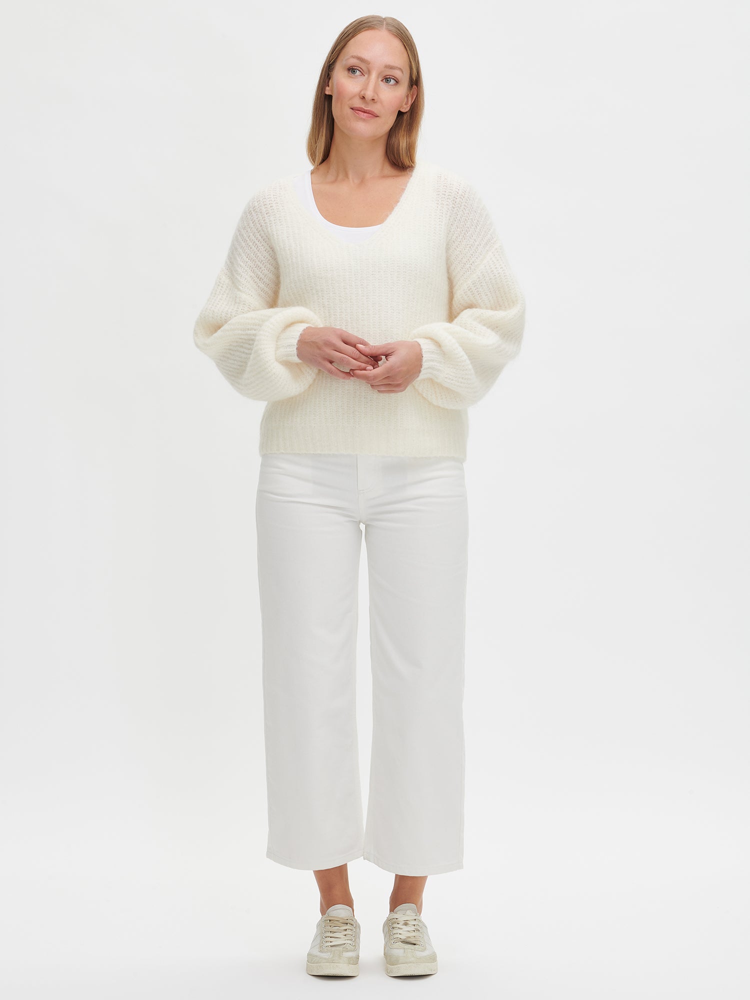 Nanso women's cozy off-white Karamelli knit sweater with a V-neckline, on a model