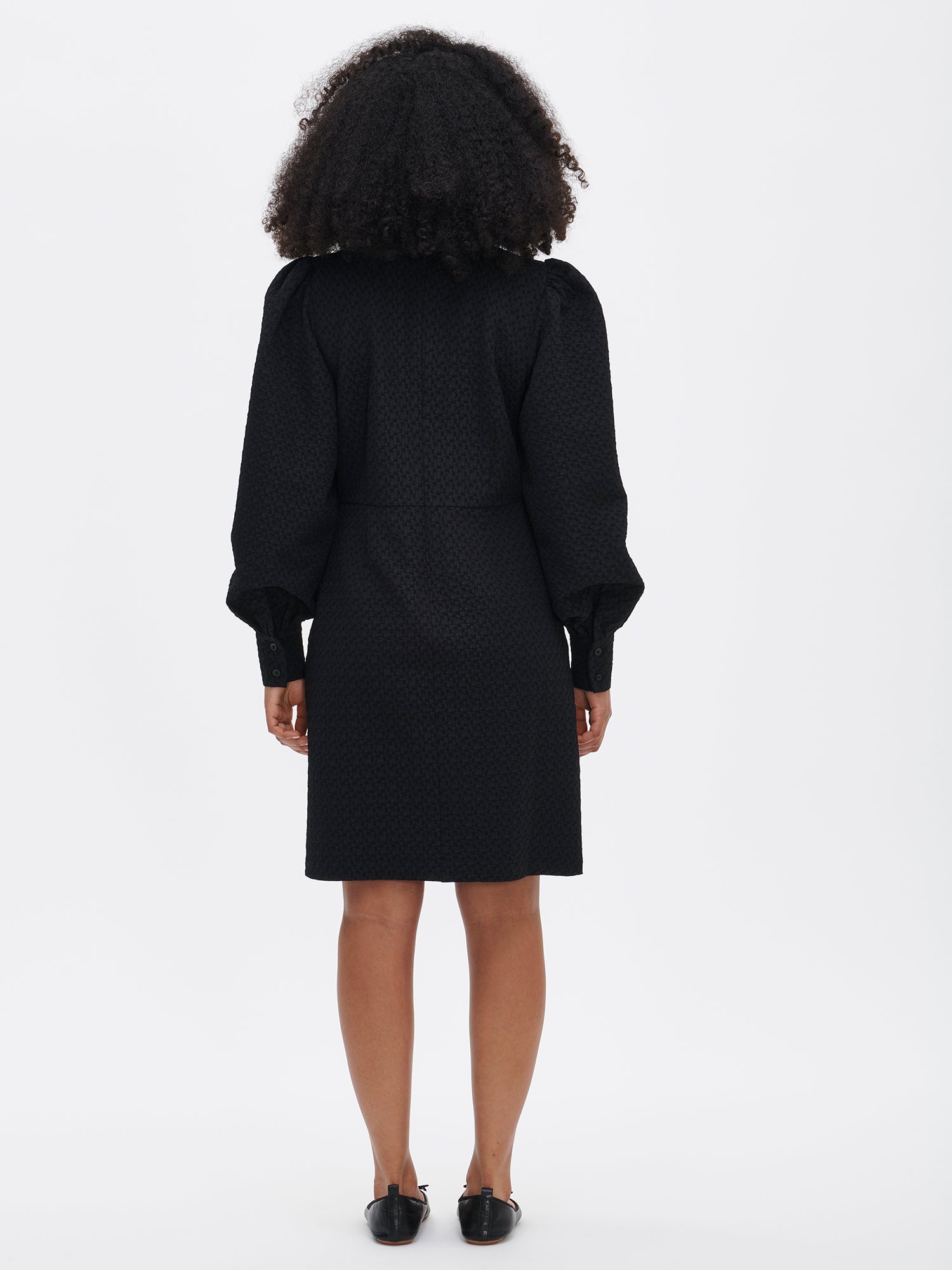 Nanso's elegant black Reliefi dress. On a model in size 36, back