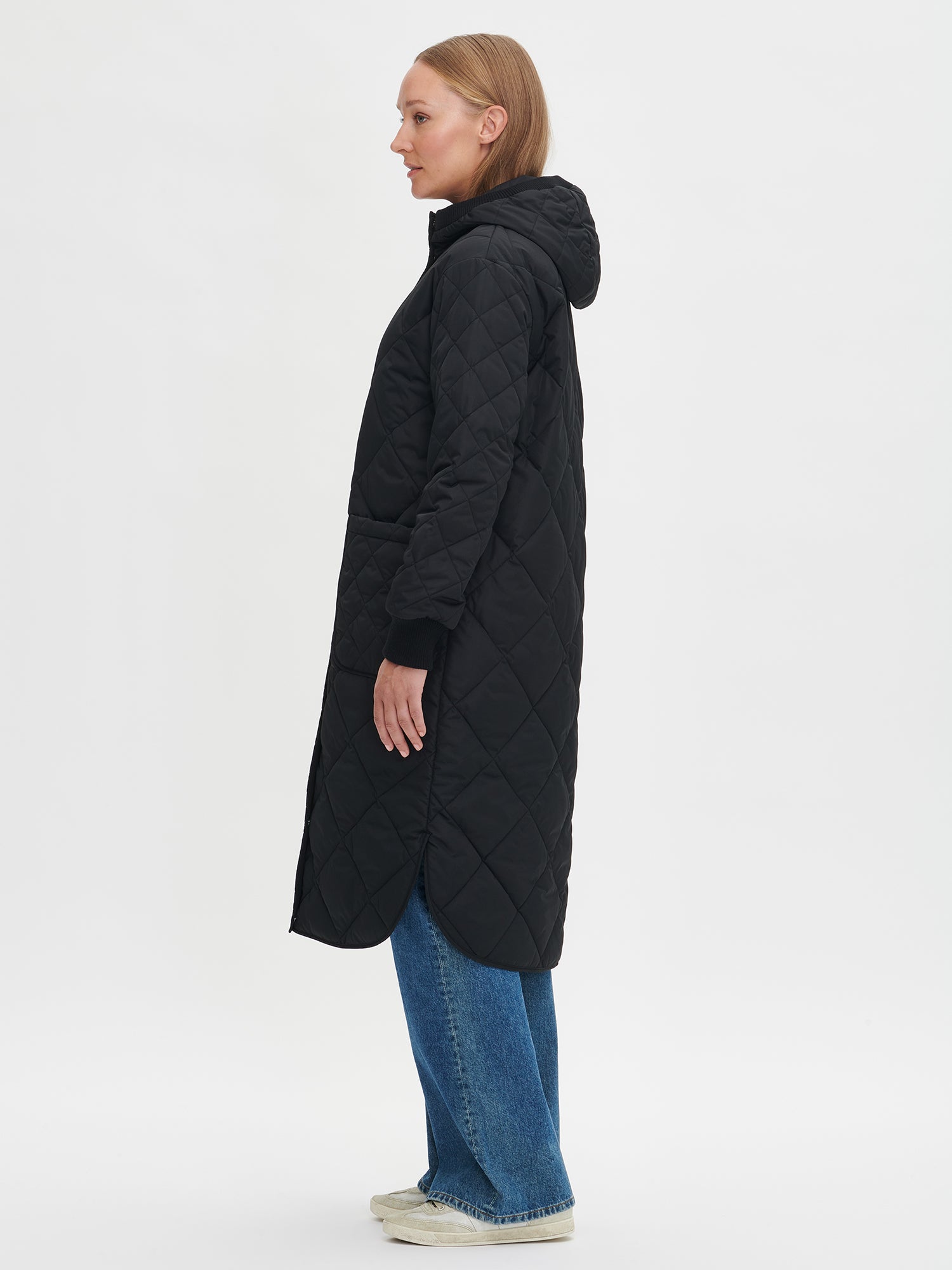Nanso women's casual black Maxi quilted coat with light padding and a cozy hood. On a model in size S, side
