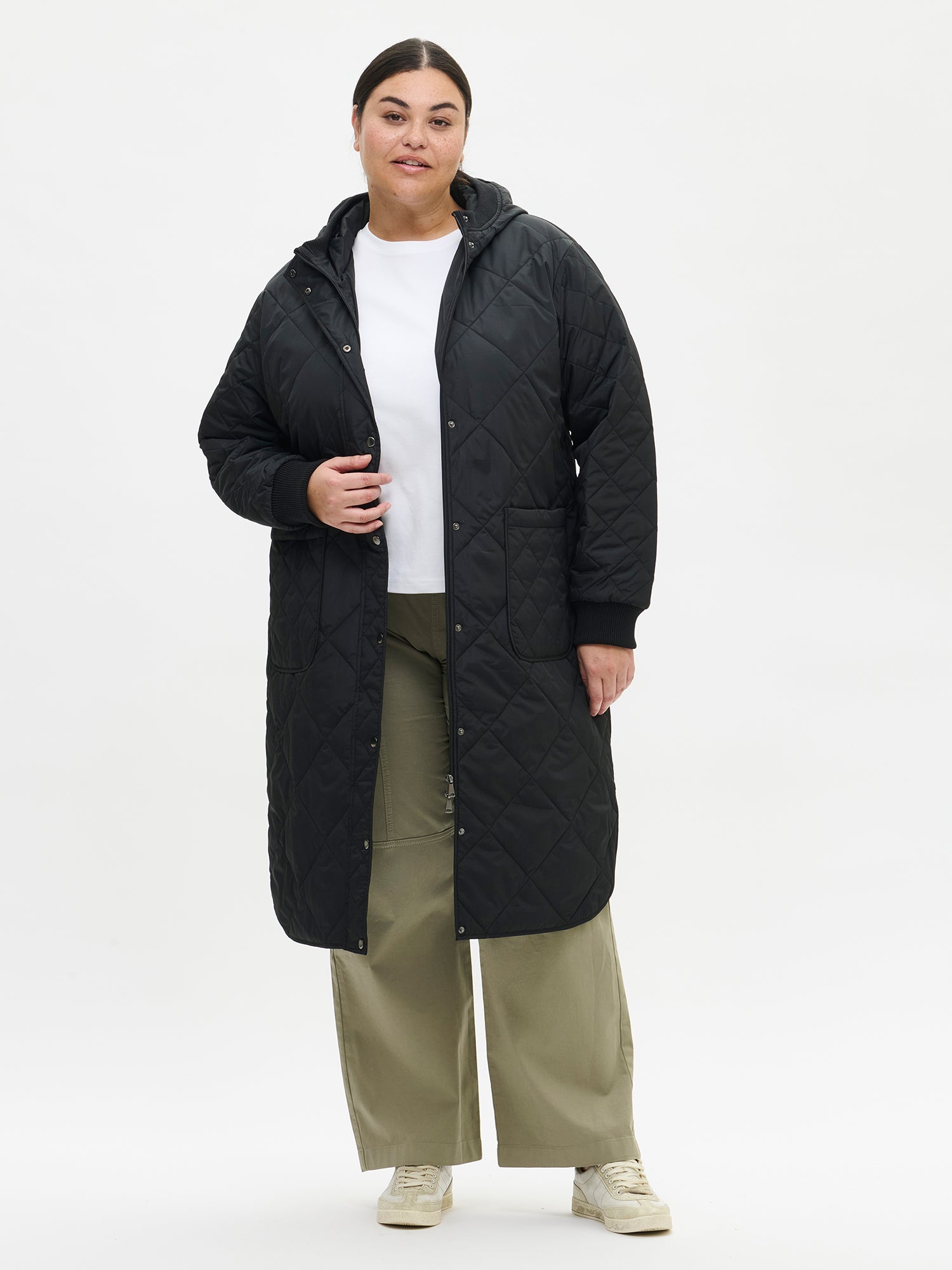 Nanso women's casual black Maxi quilted coat with light padding and a cozy hood. On a model in size XL, front