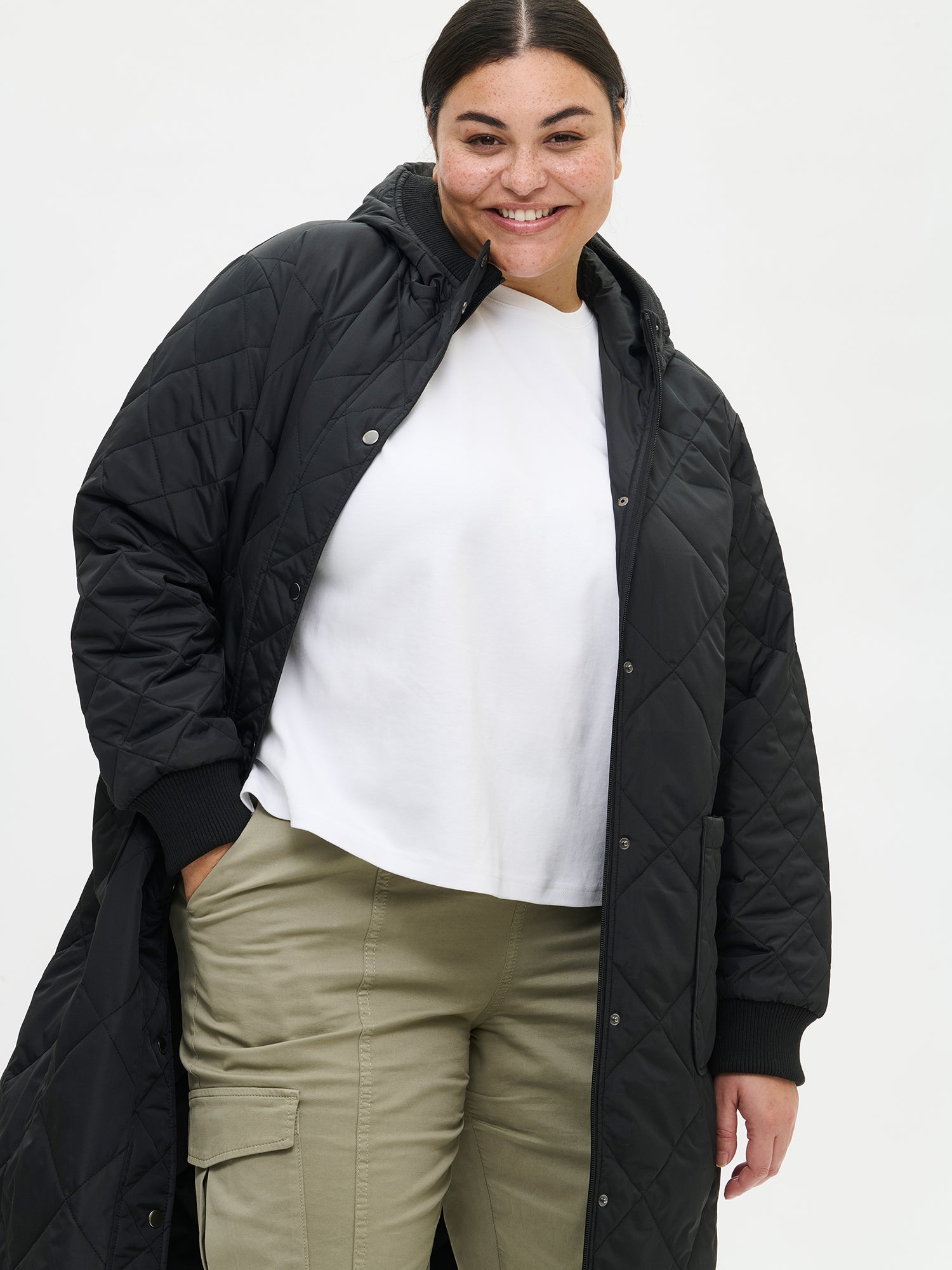 Nanso women's casual black Maxi quilted coat with light padding and a cozy hood. On a model in size XL, front close-up