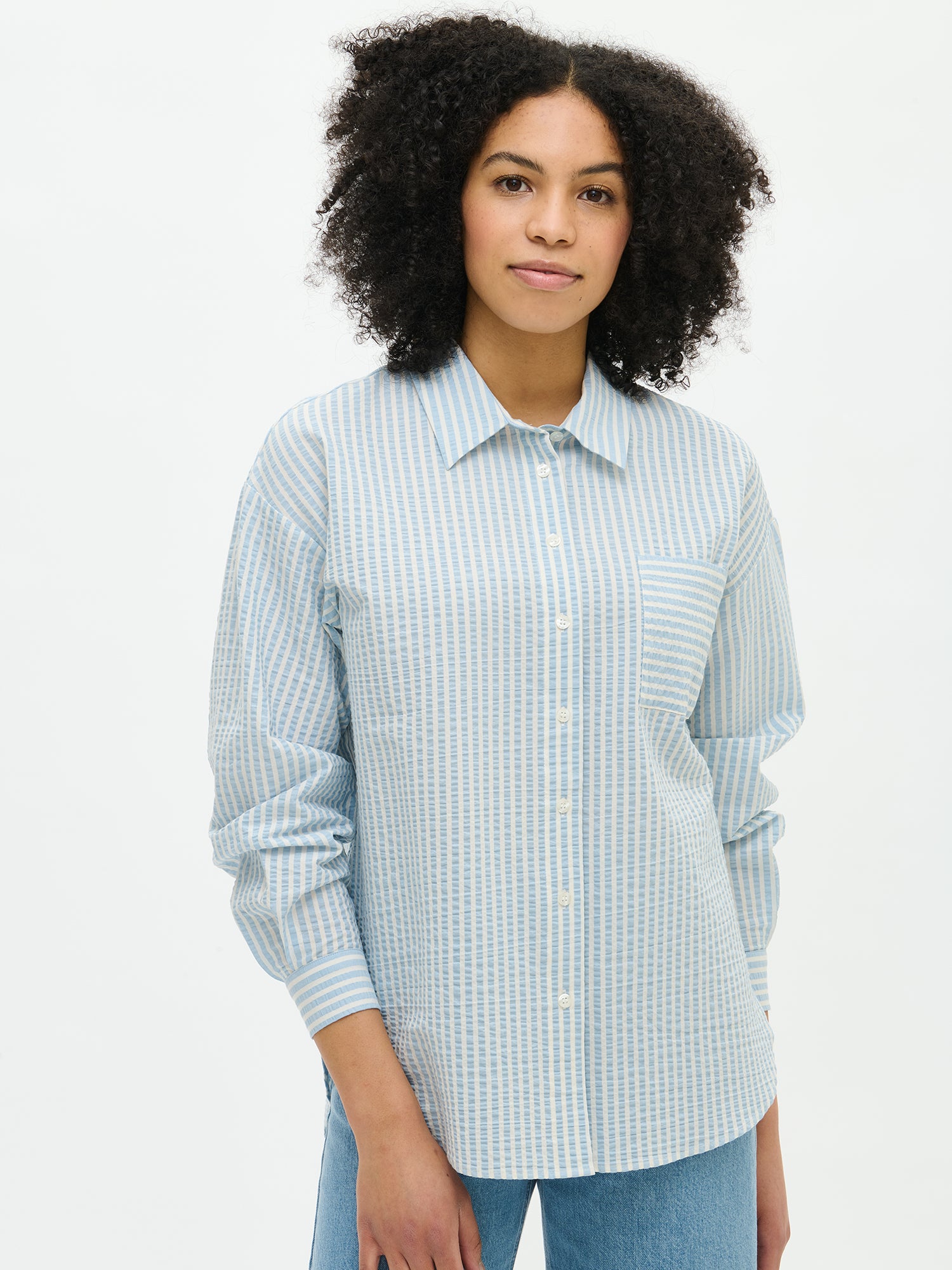 Nanso women's Marea Shirt in light blue features a classic button-up shirt with a timeless and striped pattern, close-up