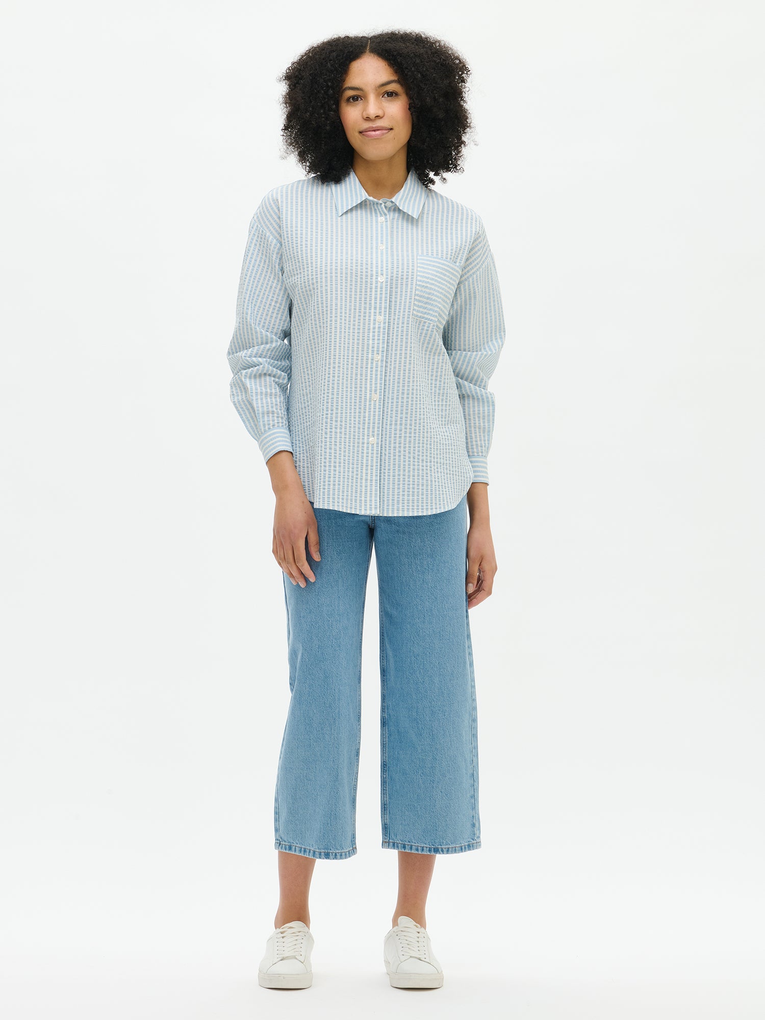 Nanso women's Marea Shirt in light blue features a classic button-up shirt with a timeless and striped pattern, from the front