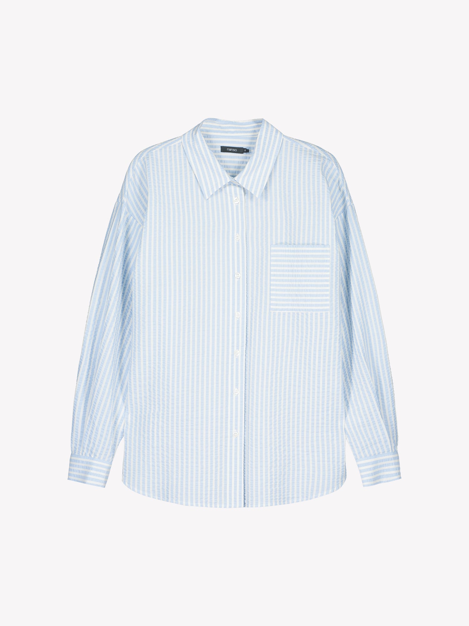 Nanso women's Marea Shirt in light blue features a classic button-up shirt with a timeless and striped pattern.