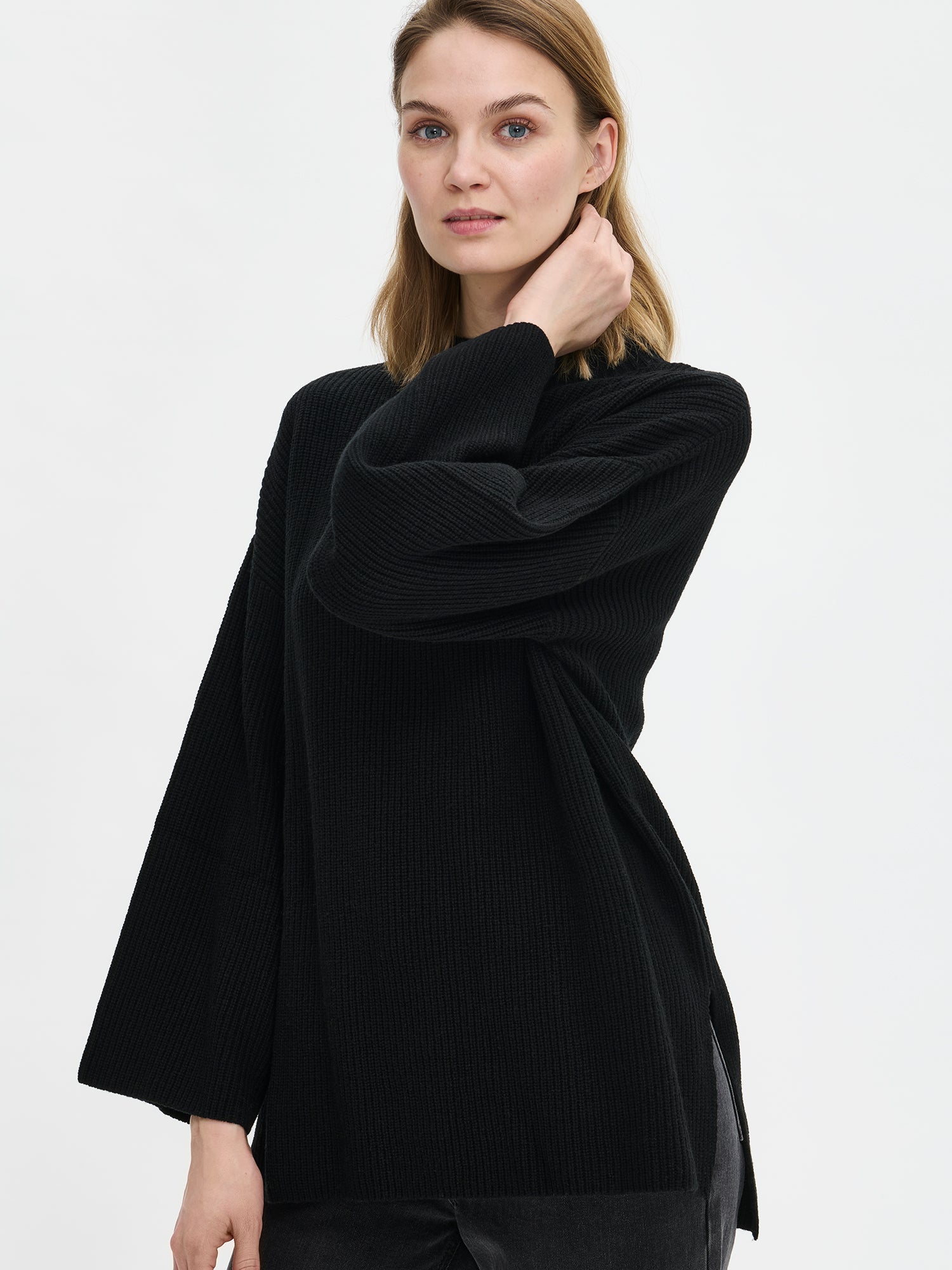 Nanso's relaxed black Pamela knit tunic from the side